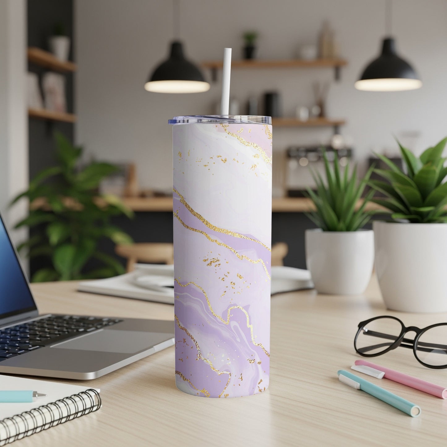 Purple and white marble tumbler with gold accents on a desk.