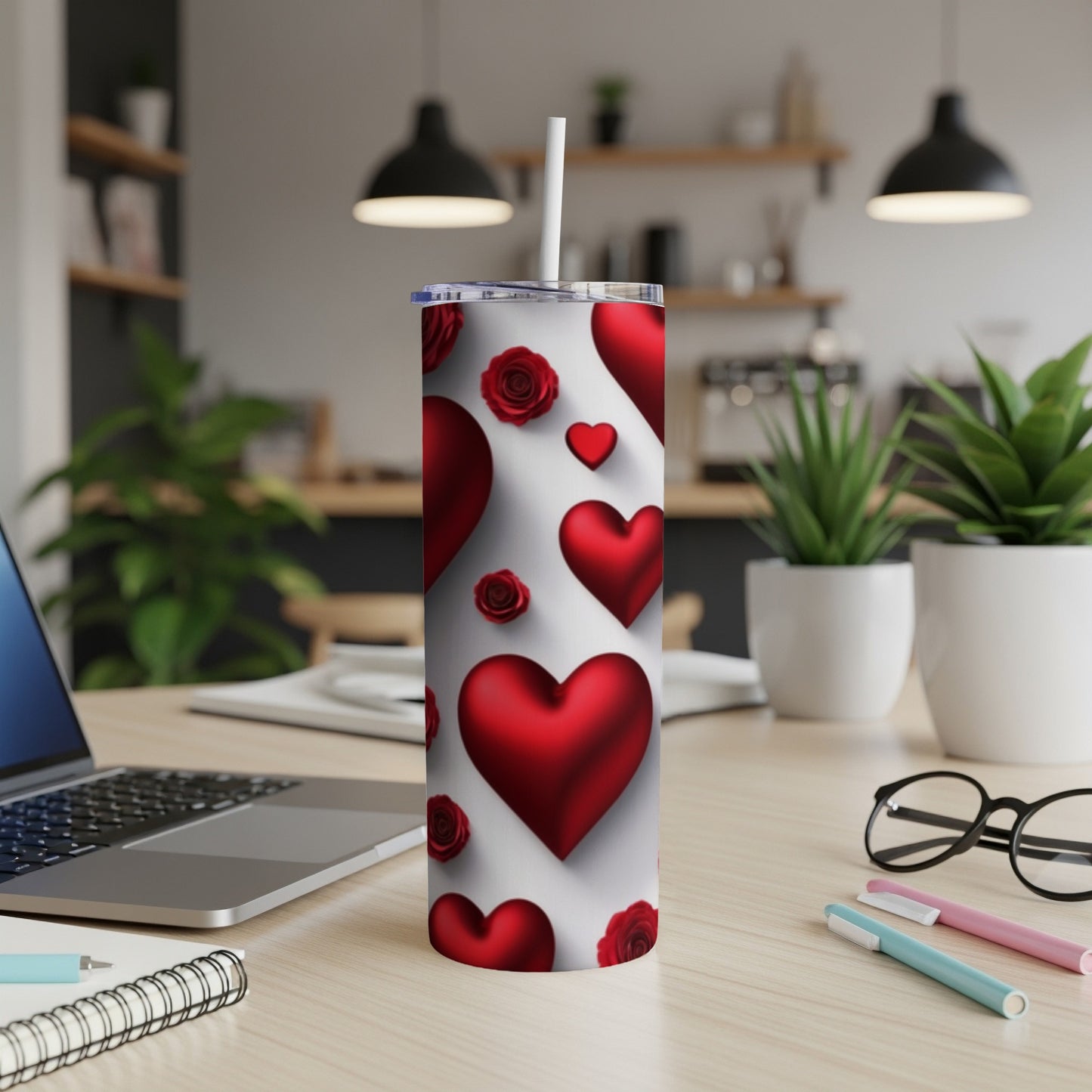 Red hearts and roses pattern on a white tumbler with a straw.