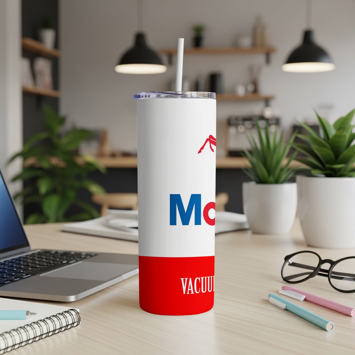 White and red tumbler with "Mobil" logo on a desk.