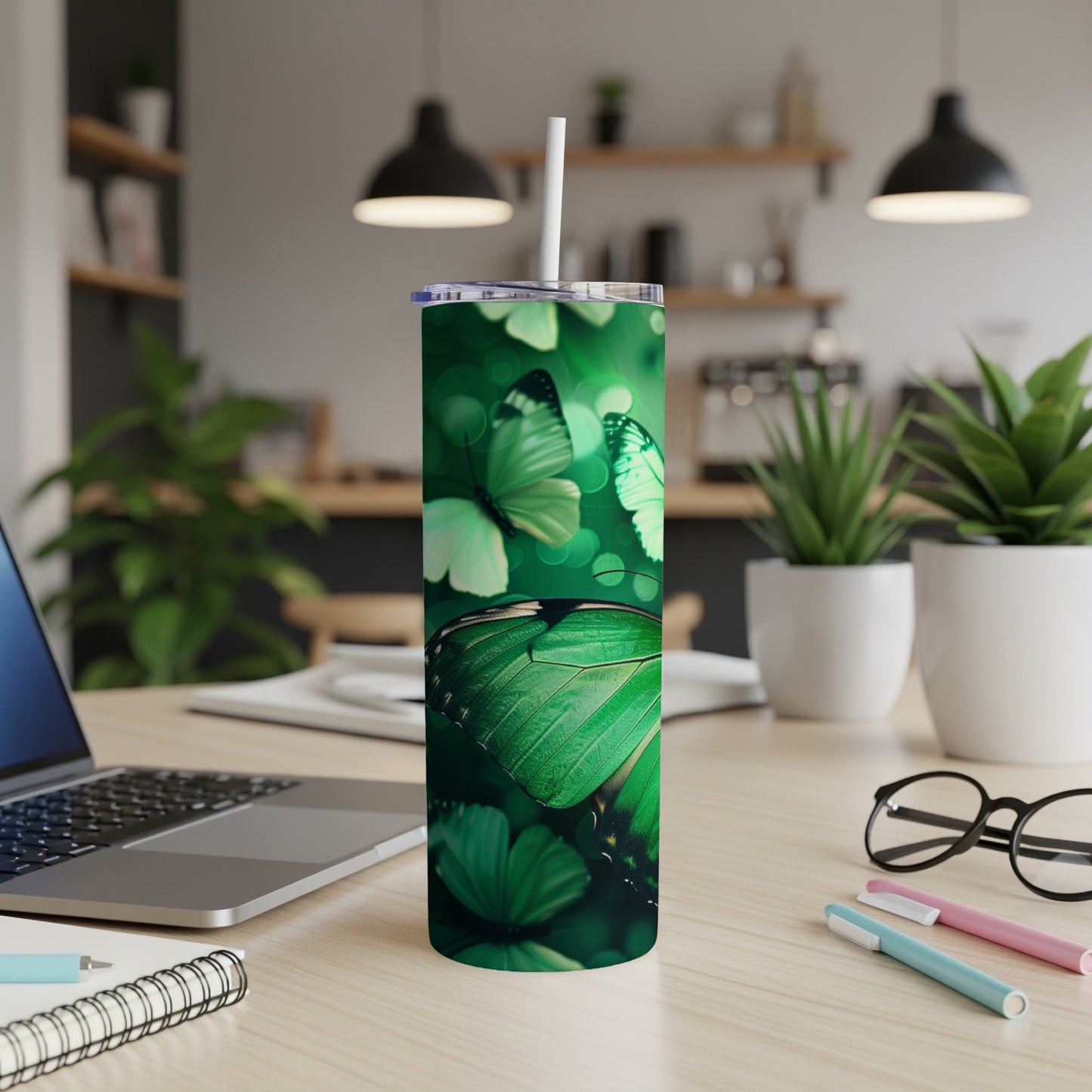 Green butterfly pattern on a white tumbler with blurred background.