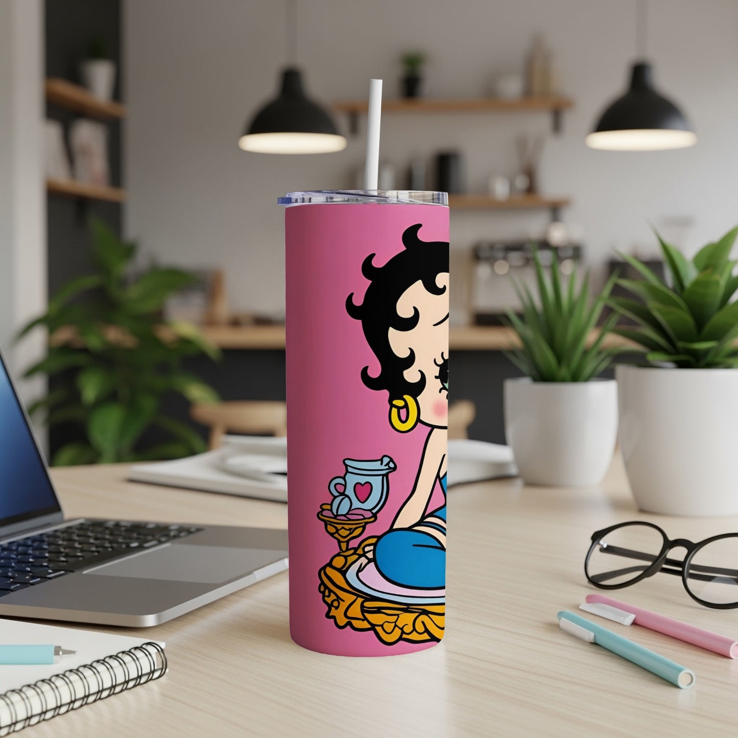 Betty Boop cartoon character on a pink tumbler with a straw.