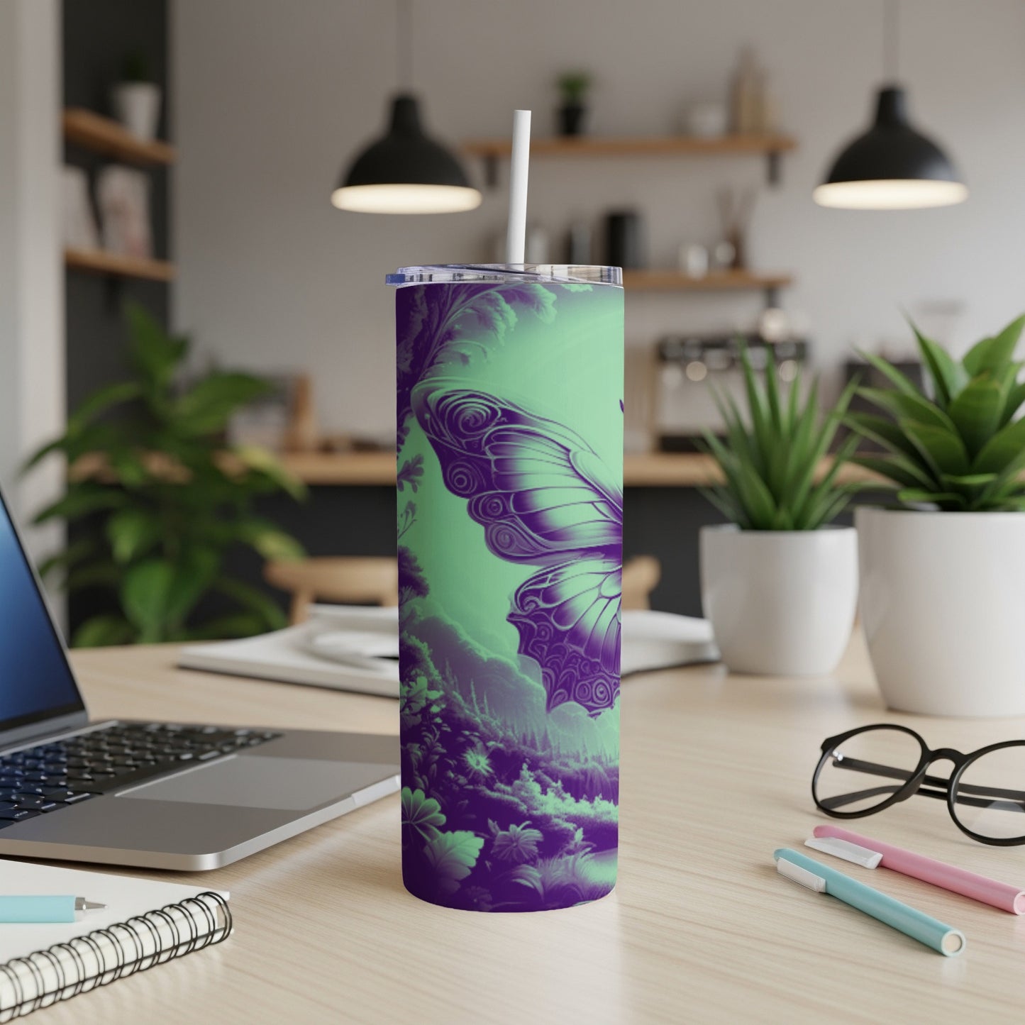 Purple and green butterfly design on a tumbler with a straw.