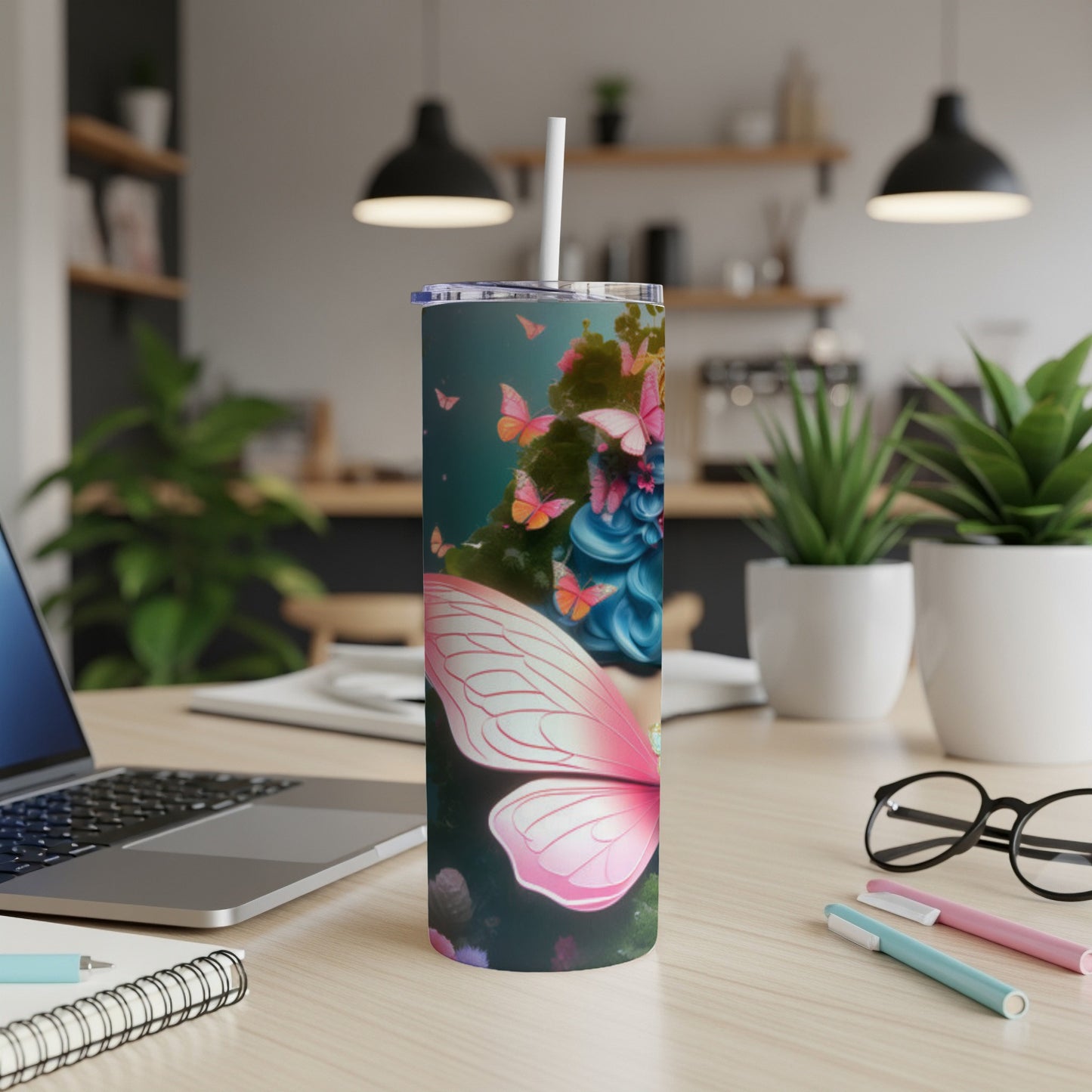 Pink butterfly wings and blue hair on a tumbler with a white straw.