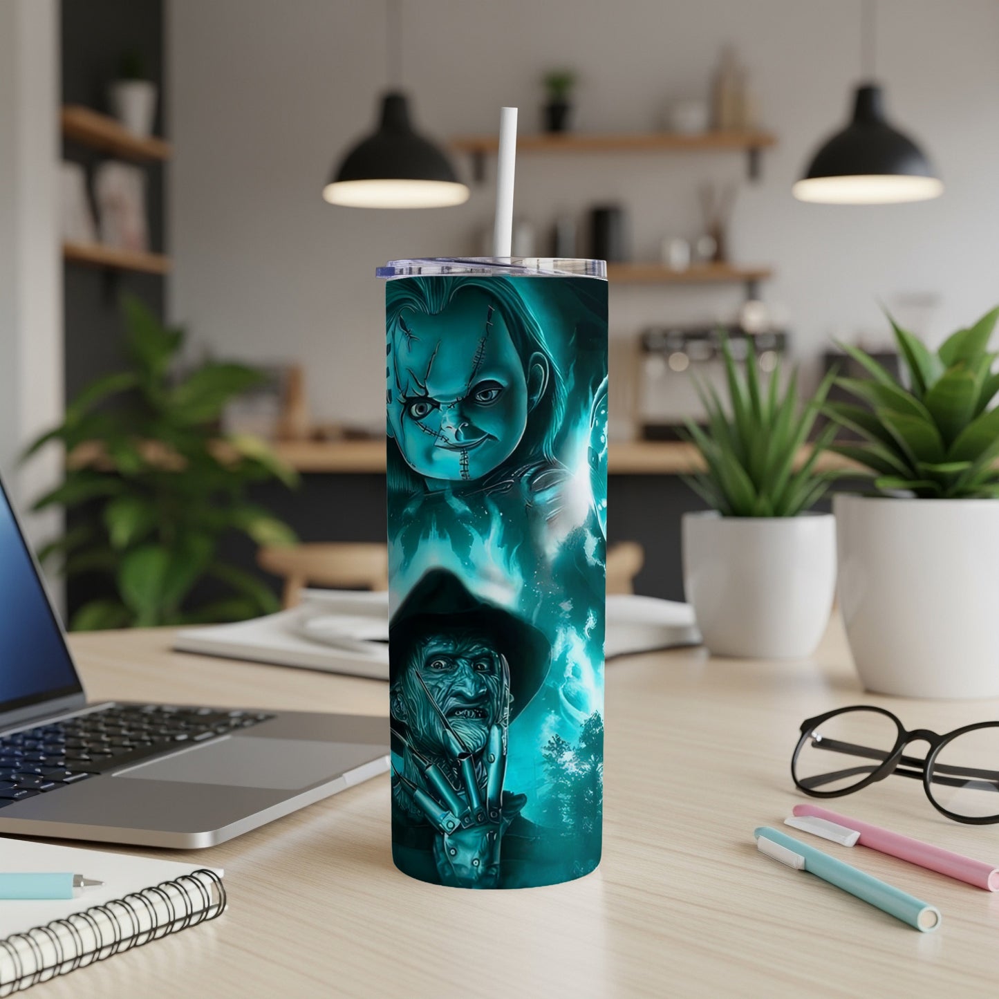 Horror movie characters Chucky and Freddy Krueger on a teal tumbler.