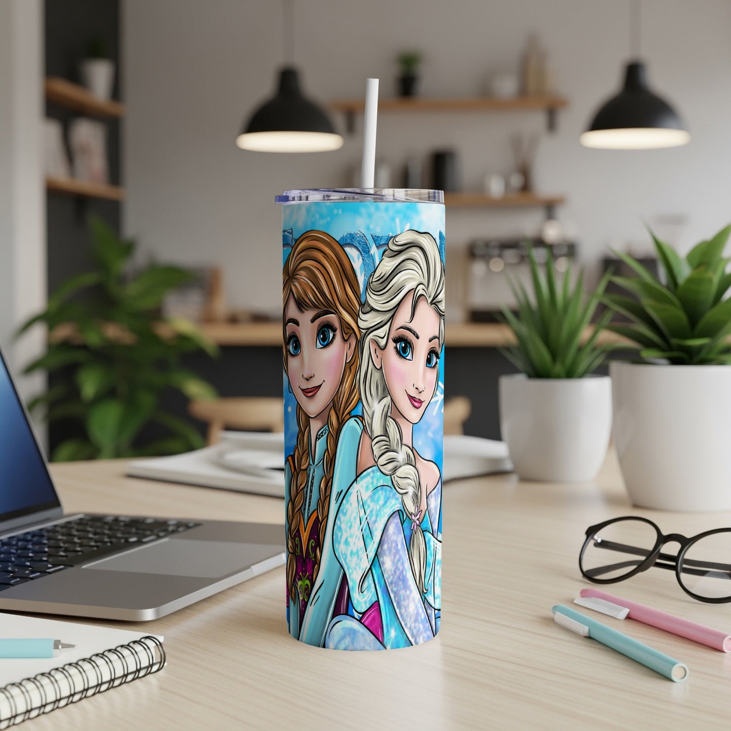 Elsa and Anna from Frozen on a blue patterned tumbler cup.
