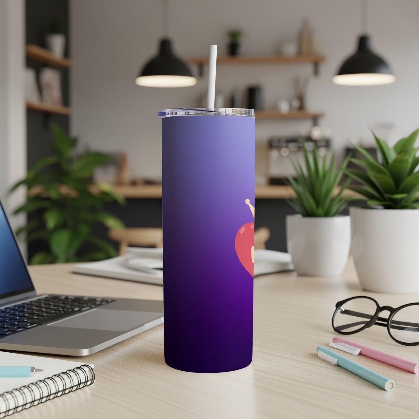 Purple gradient tumbler with a red heart and crown, on a desk.