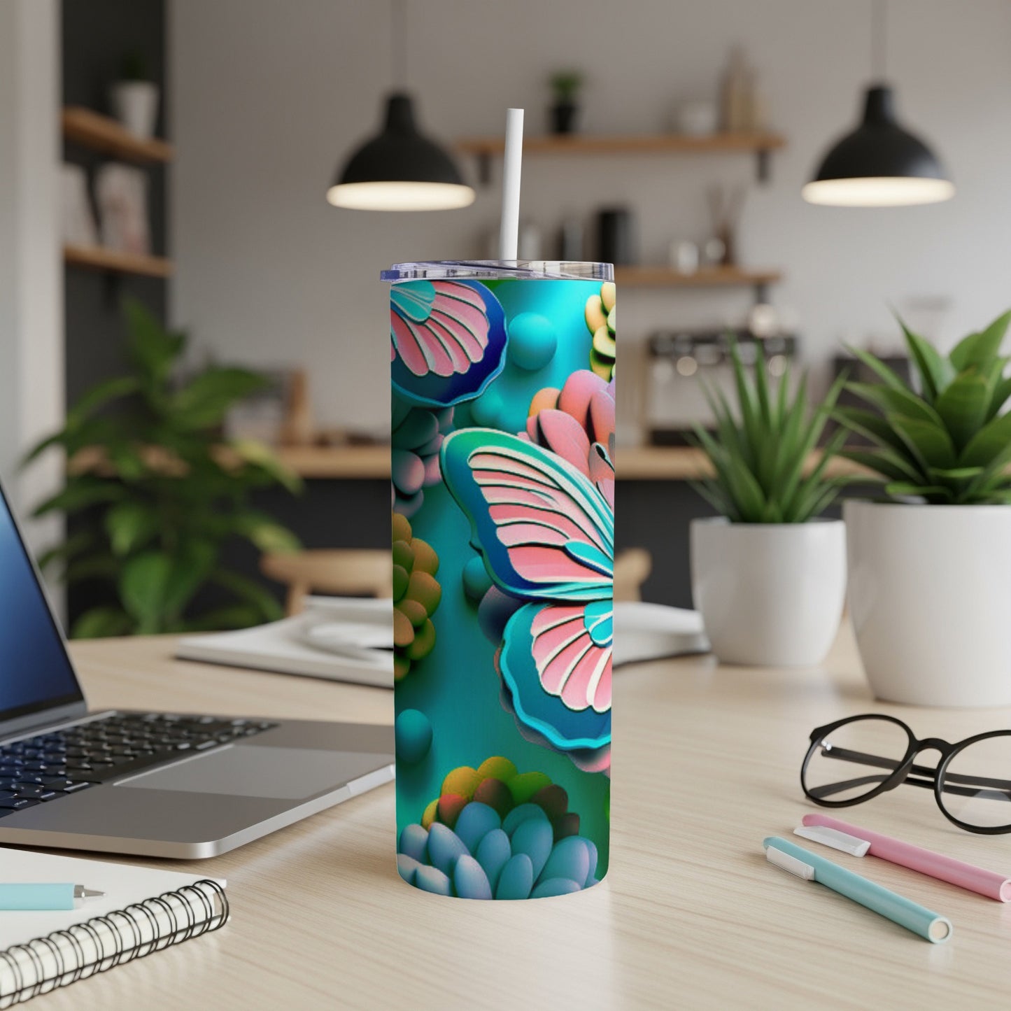 Tall tumbler with a teal background and butterfly and succulent design.