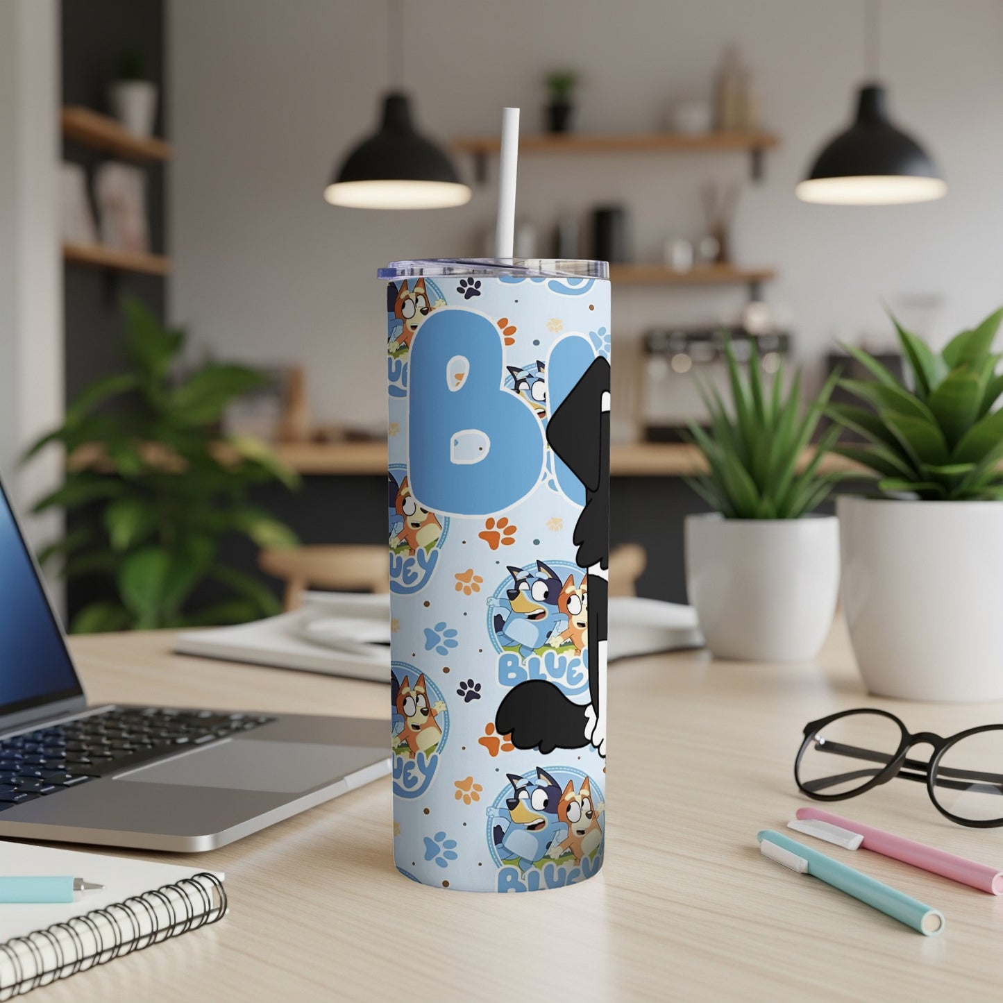 Bluey character tumbler with straw on a desk.