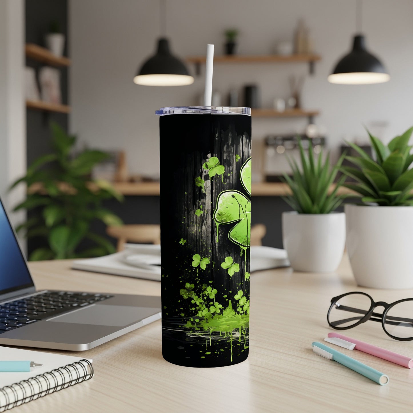 Black tumbler with dripping green shamrocks and splatter design.