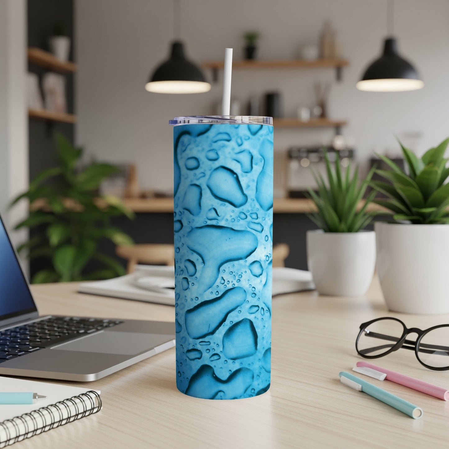 Blue water drop pattern on a stainless steel tumbler with straw.
