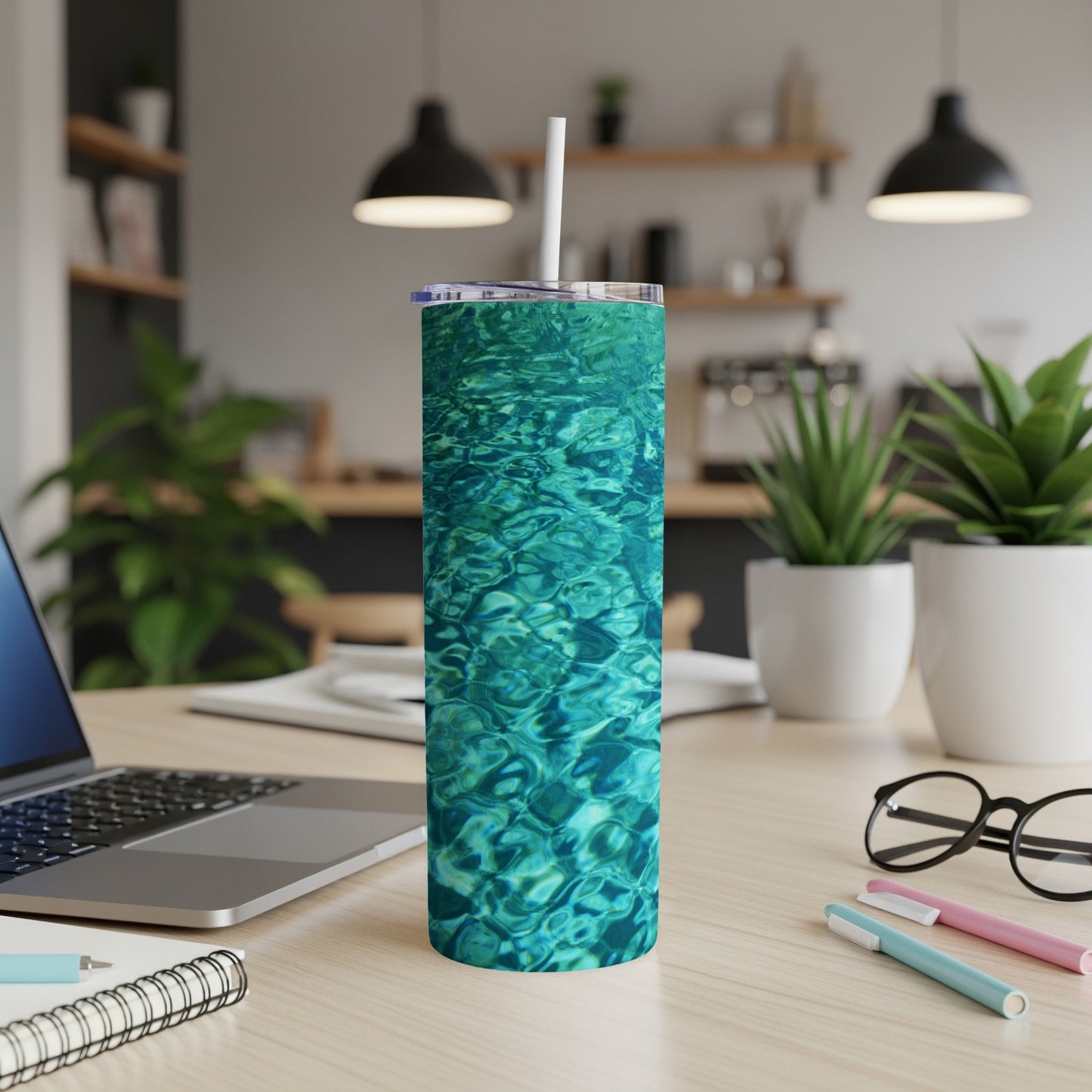 Turquoise water pattern on a white tumbler with a straw.