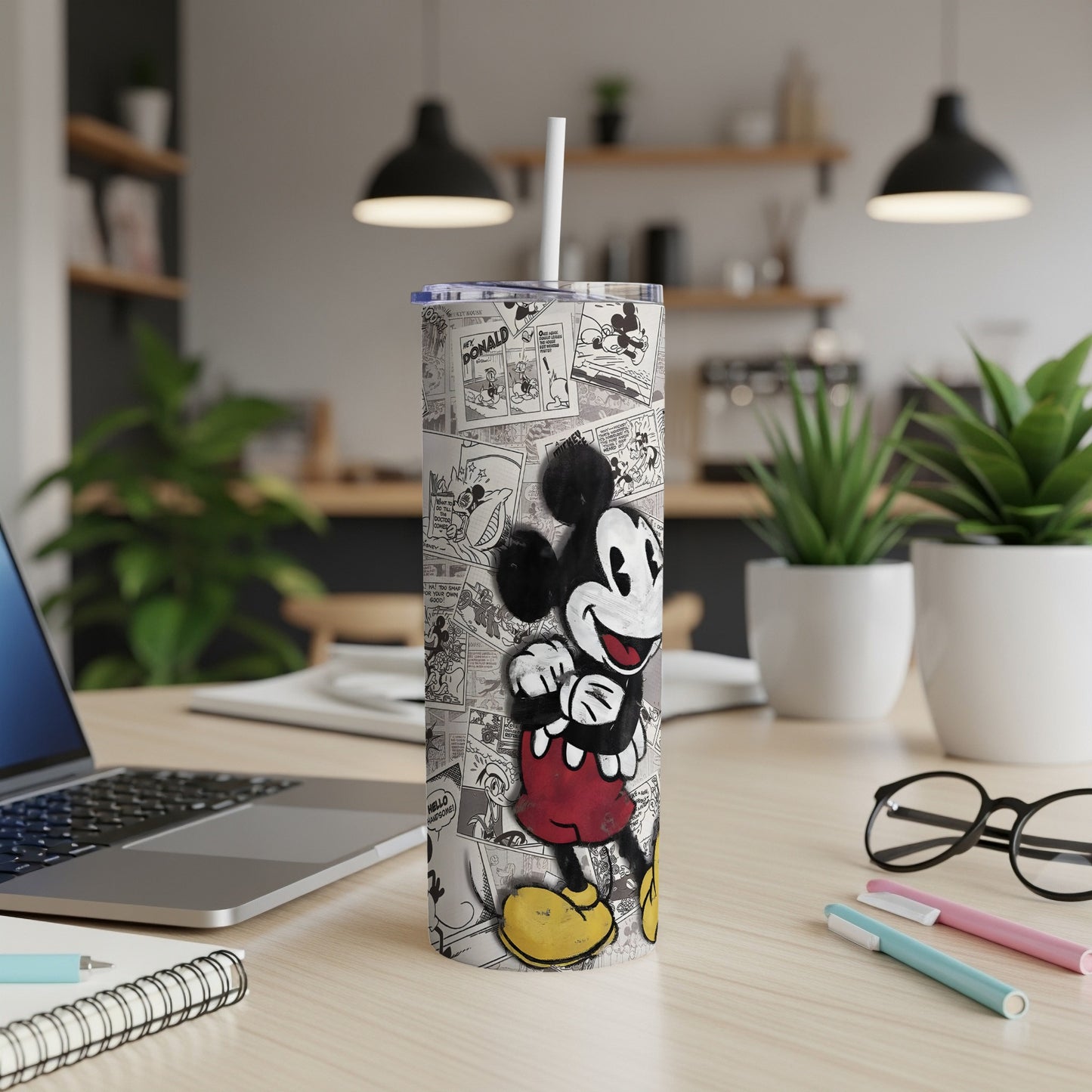 Mickey Mouse cartoon print on a white tumbler with a straw.