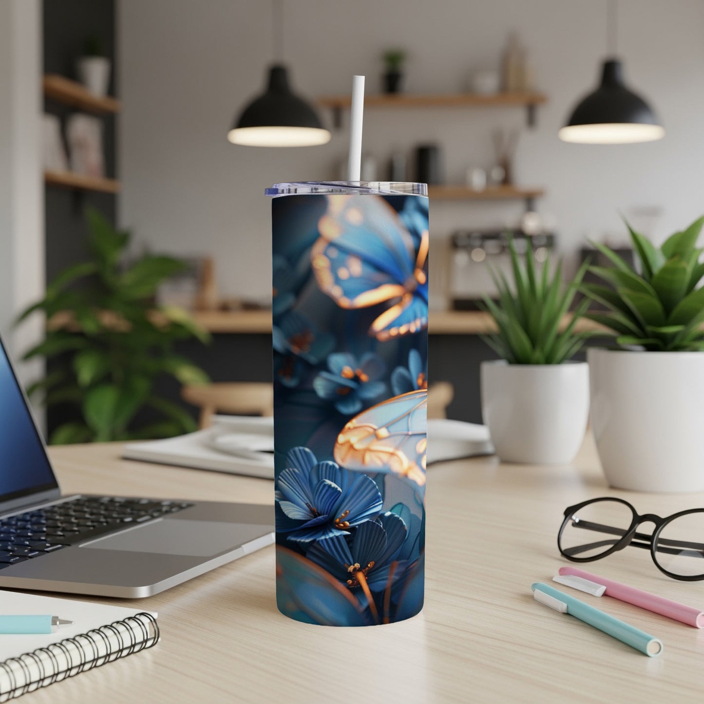 Blue butterfly and floral pattern on a stainless steel tumbler with straw.