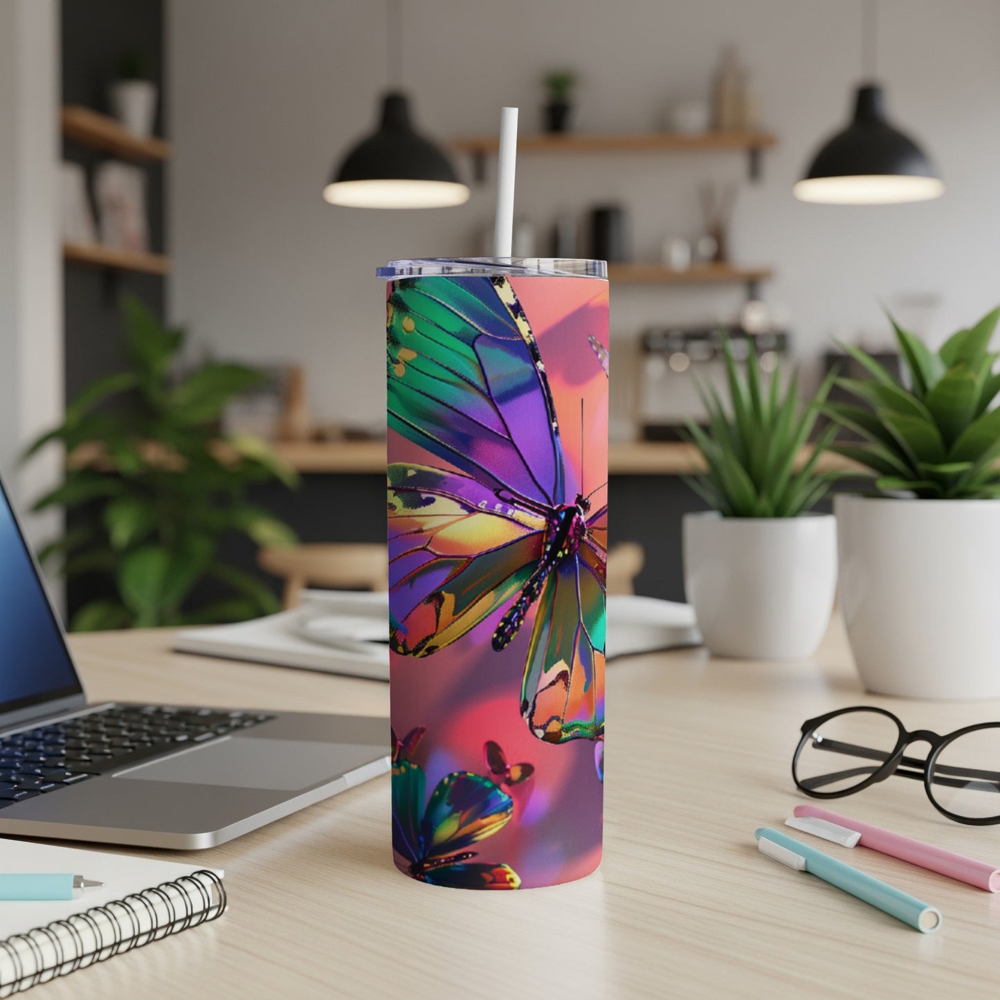 Colorful butterfly design on a skinny tumbler with a white straw.