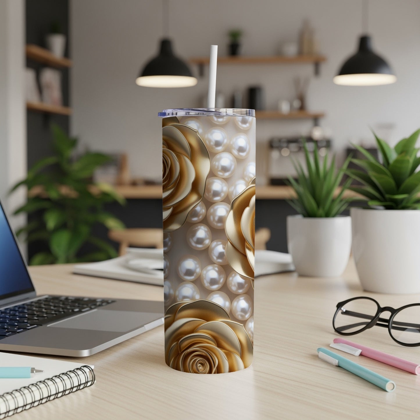 Gold rose and pearl pattern on a white skinny tumbler with straw.