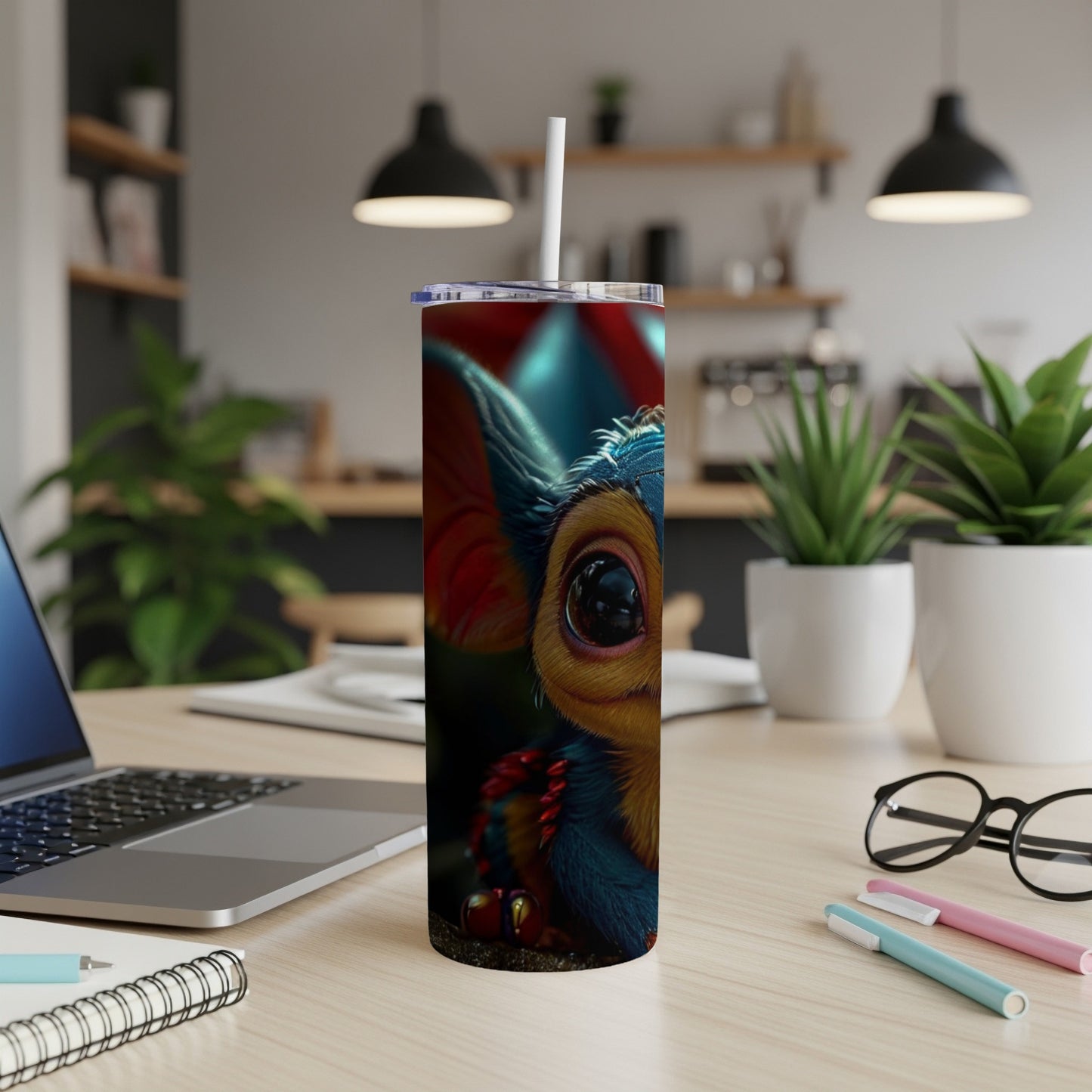 Fuzzy creature with large eyes on a red and blue striped tumbler.
