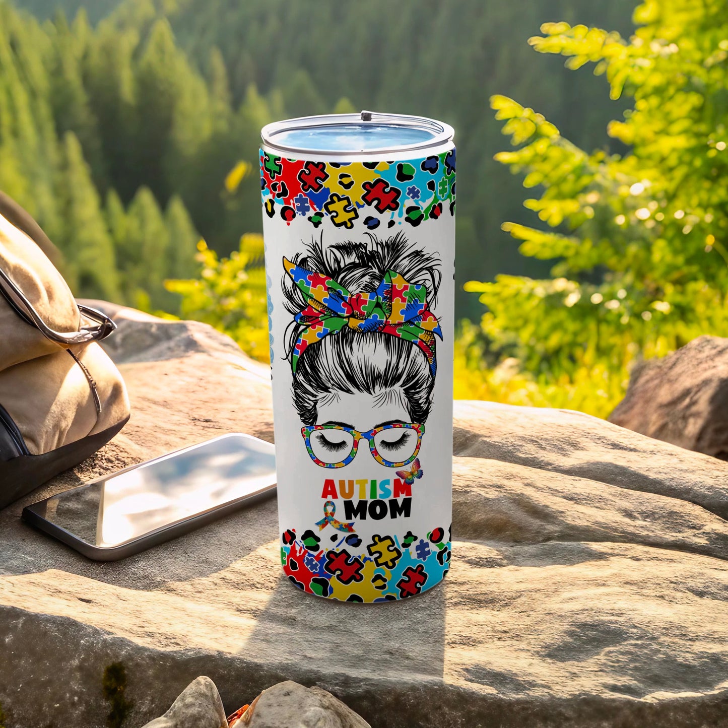 Tumbler with colorful puzzle pieces and "Autism Mom" text.