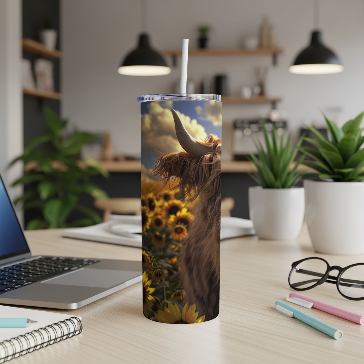Highland cow in a sunflower field on a travel tumbler.