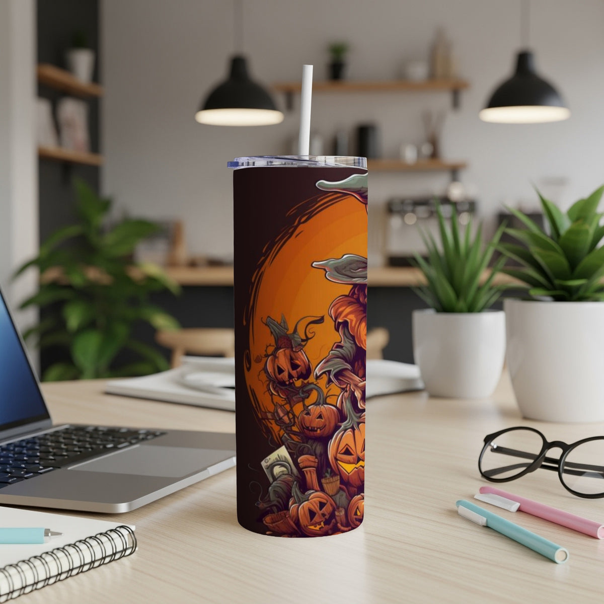 Halloween tumbler with jack-o'-lanterns and spooky figures on an orange background.