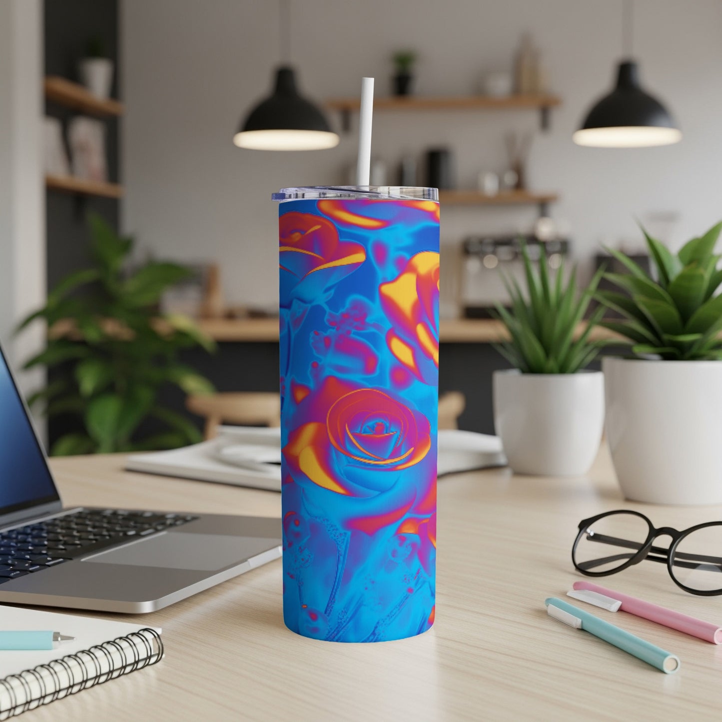 Blue tumbler with abstract floral pattern and white straw.