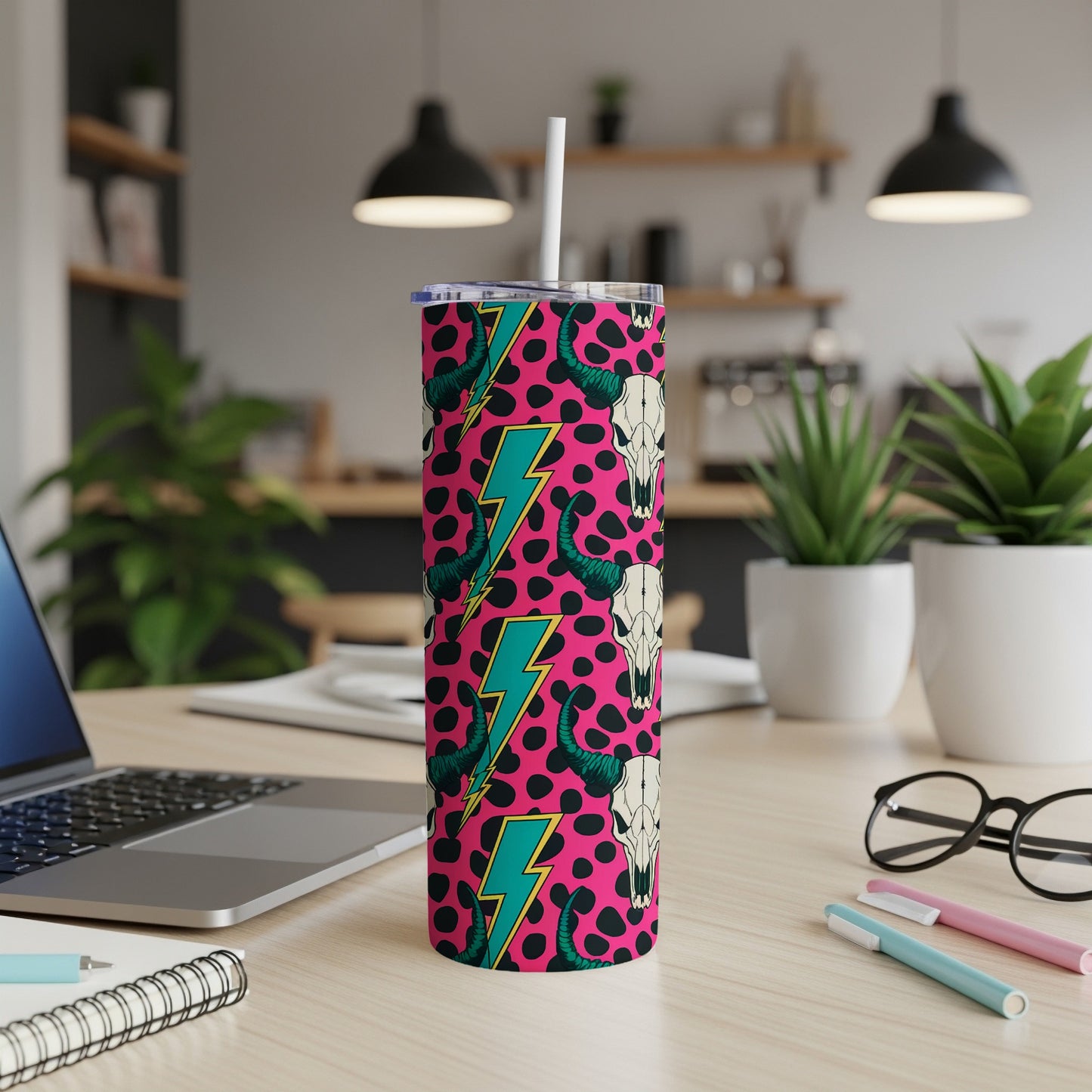 Pink skinny tumbler with cow print, lightning bolts, and bull skulls.