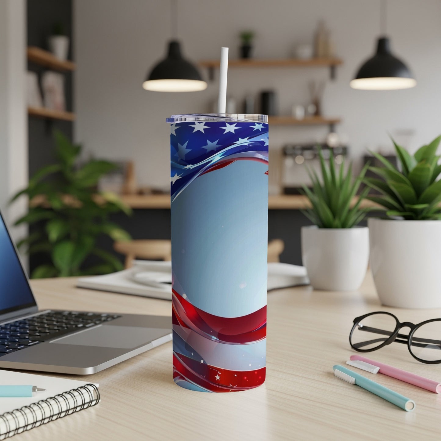 American flag pattern tumbler with straw on a desk.