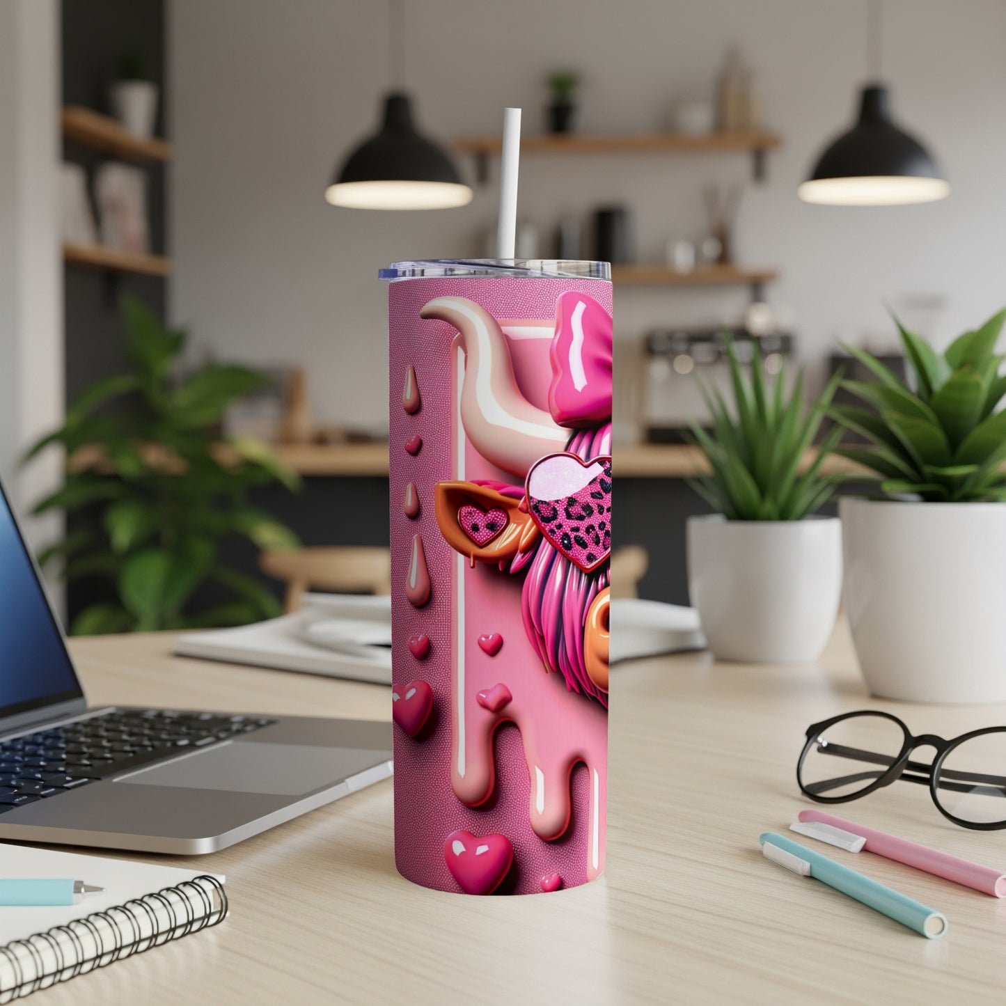 Pink glittery tumbler with a cow graphic, hearts, and a straw.