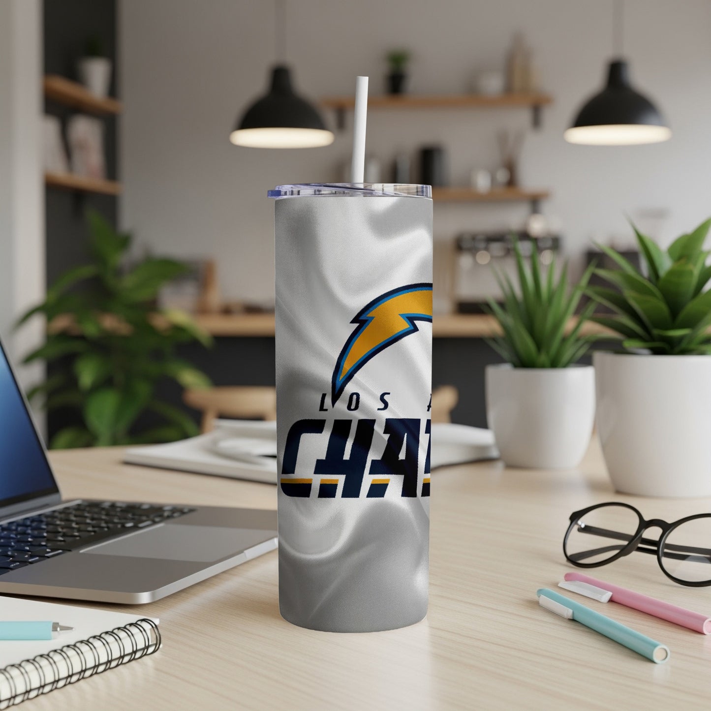 Los Angeles Chargers tumbler with lightning bolt logo on a desk.