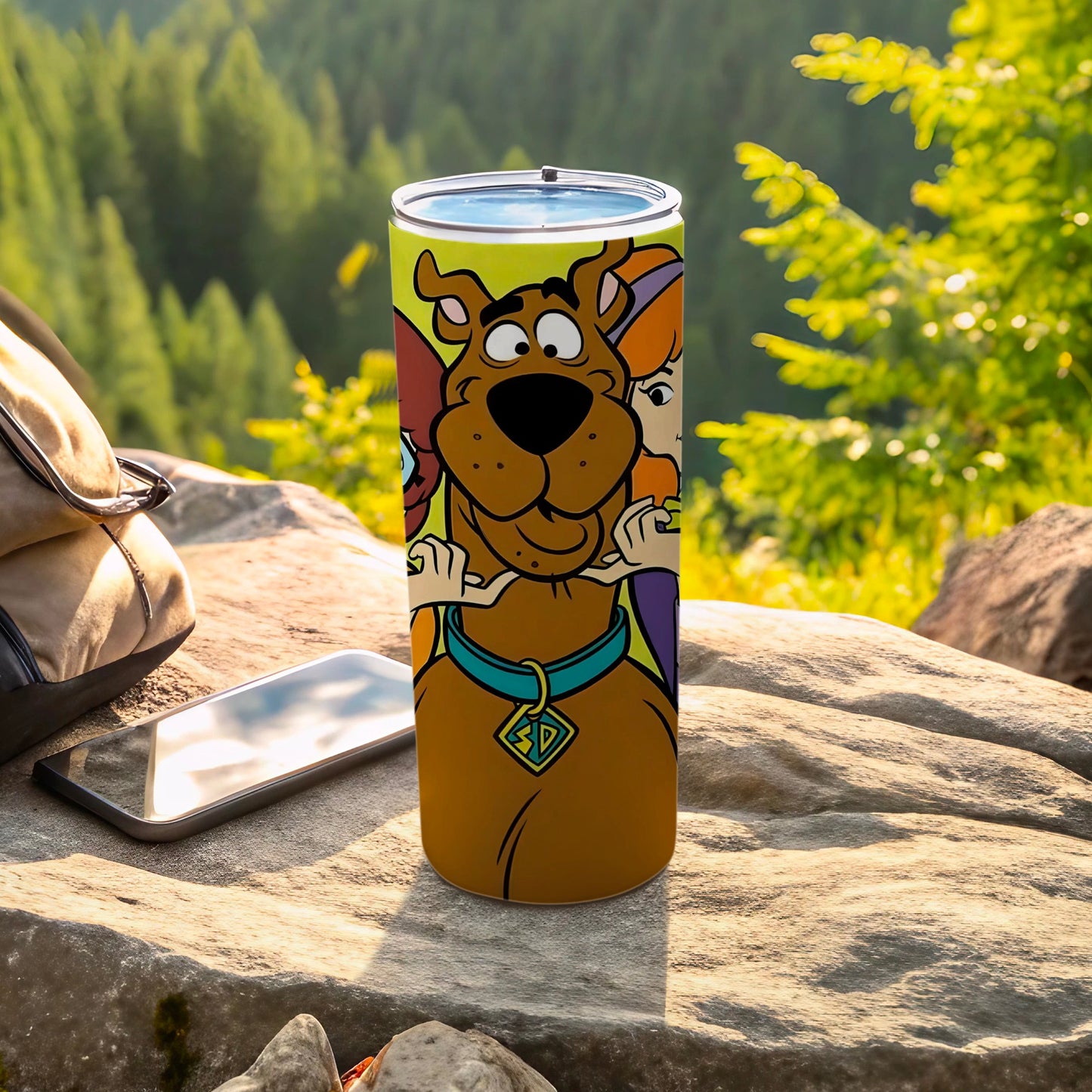 Scooby-Doo and friends featured on a travel tumbler, outdoors.