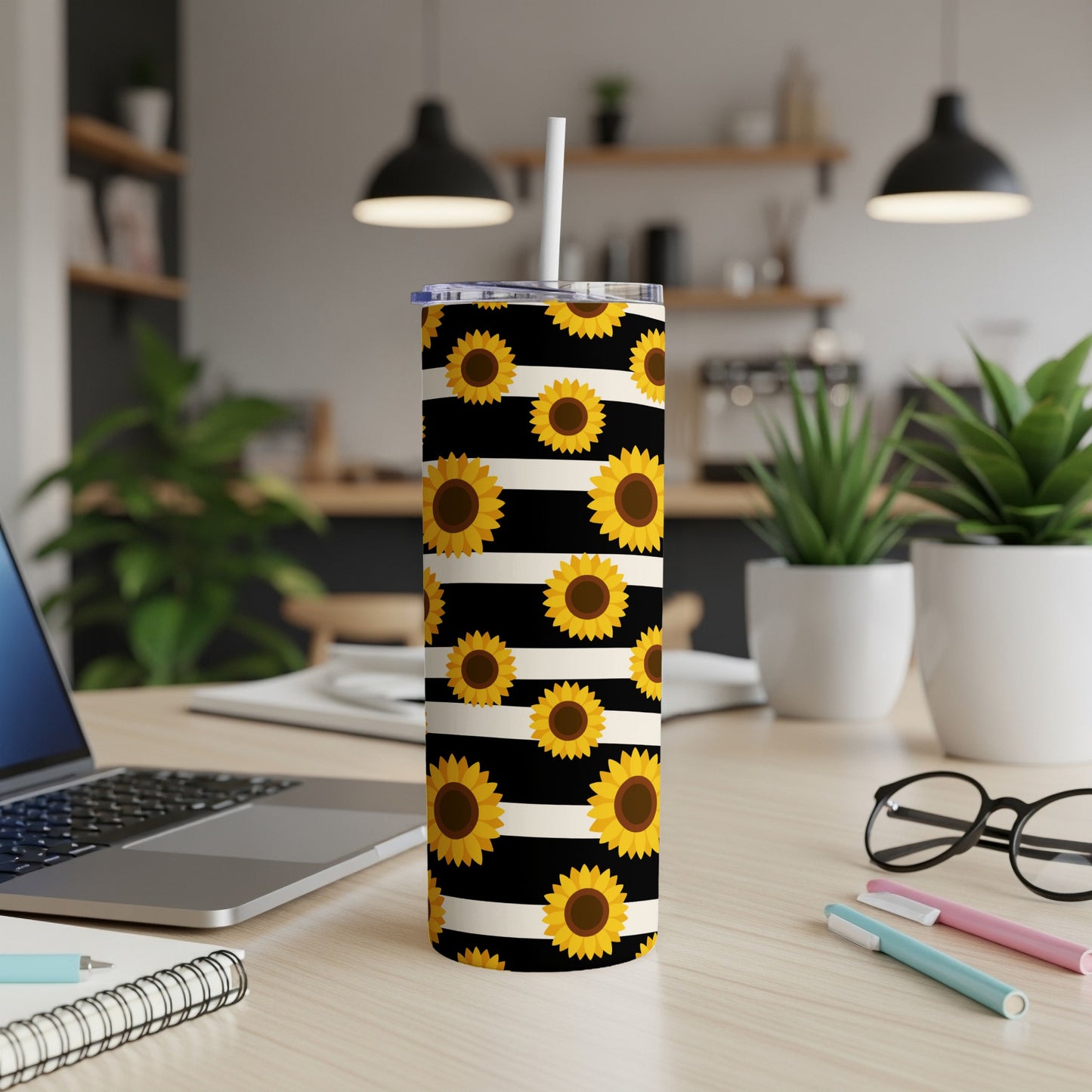 Tall tumbler with a black and white striped background and sunflower pattern.