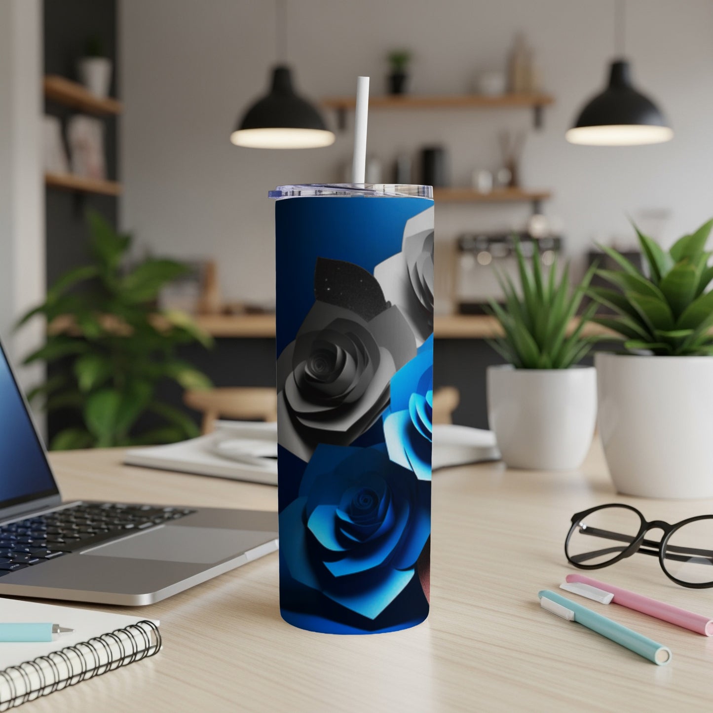 Blue and grey paper roses on a dark blue gradient tumbler with a straw.