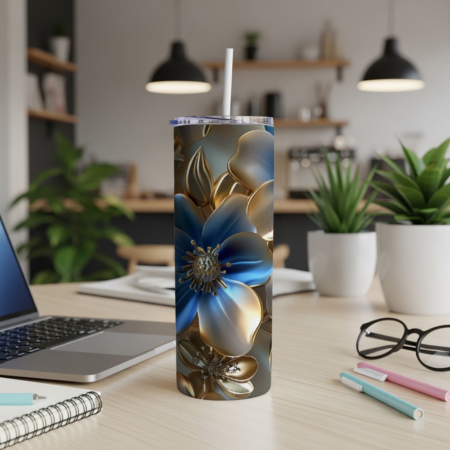 Floral pattern on a tall, slender tumbler with a white straw on a desk.