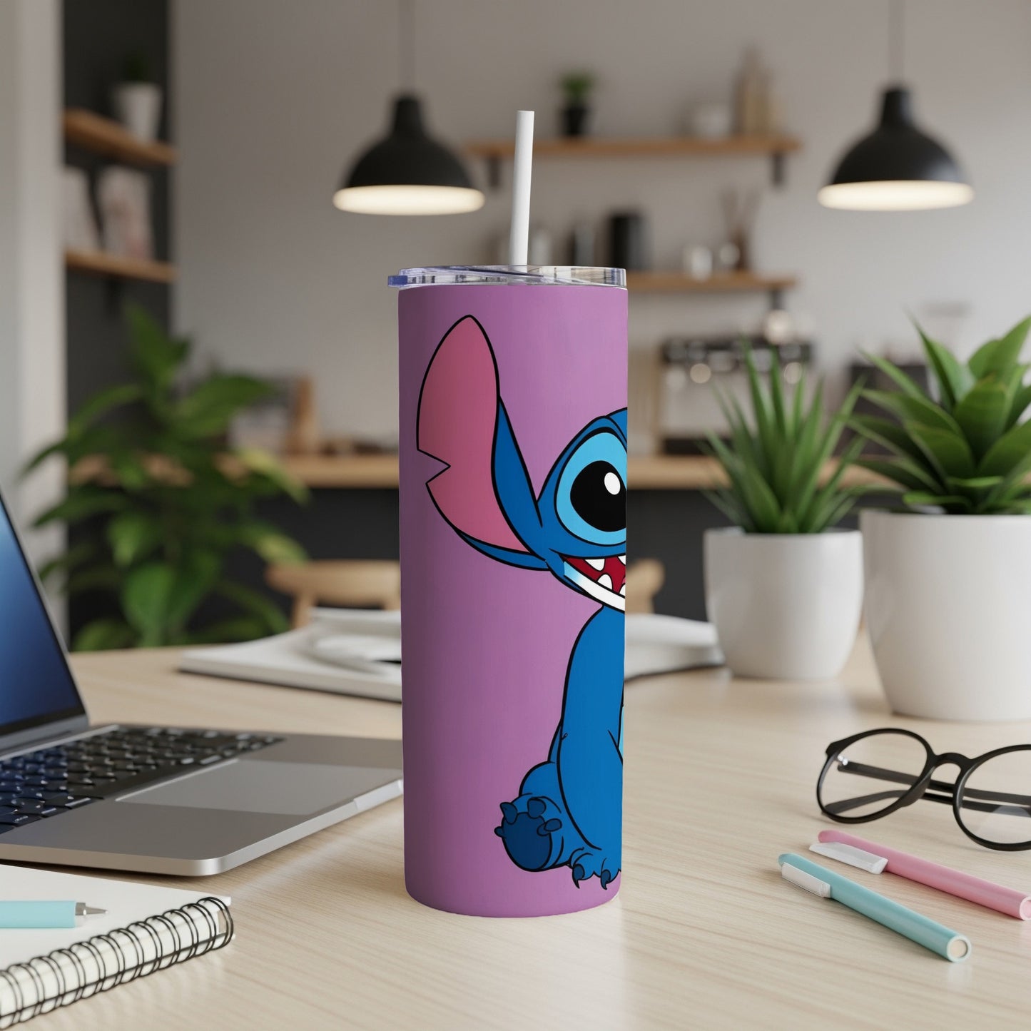 Purple tumbler with Stitch character and white straw on desk.