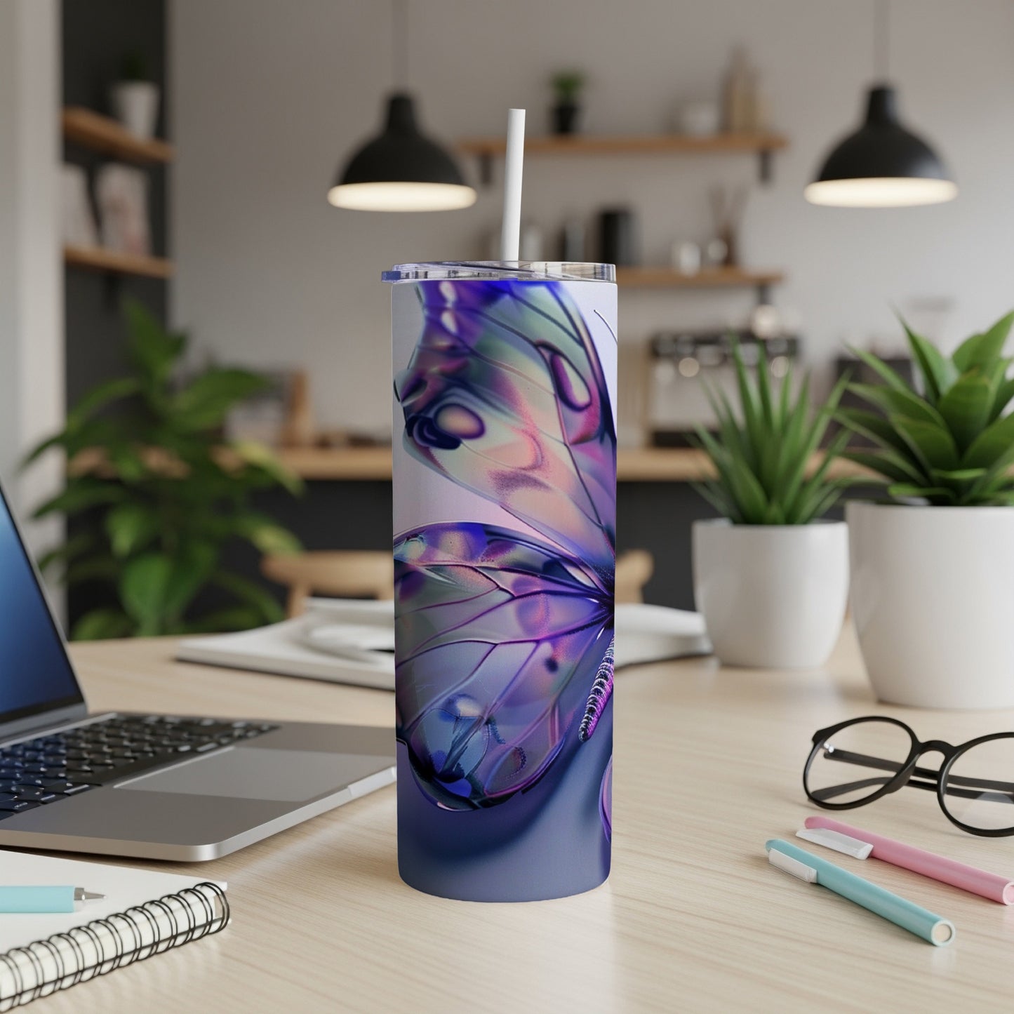 Purple butterfly design on a white tumbler with a straw, on a desk.