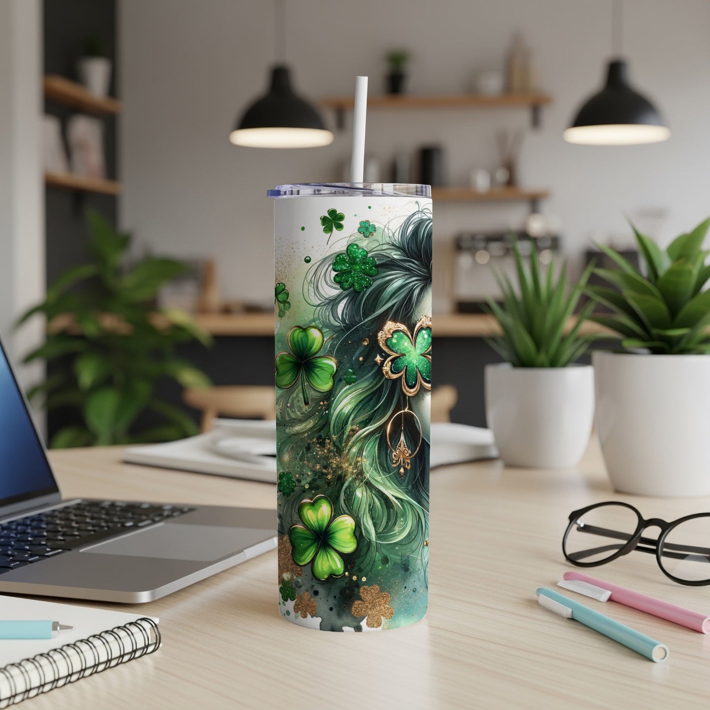 Green and gold shamrock tumbler with straw on desk.