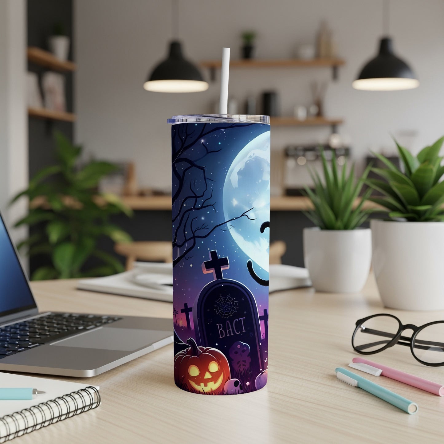 Tall tumbler with Halloween graveyard and pumpkin design.