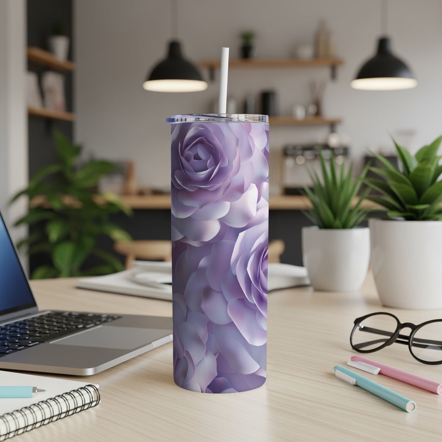 Purple floral print tumbler with straw on a desk.