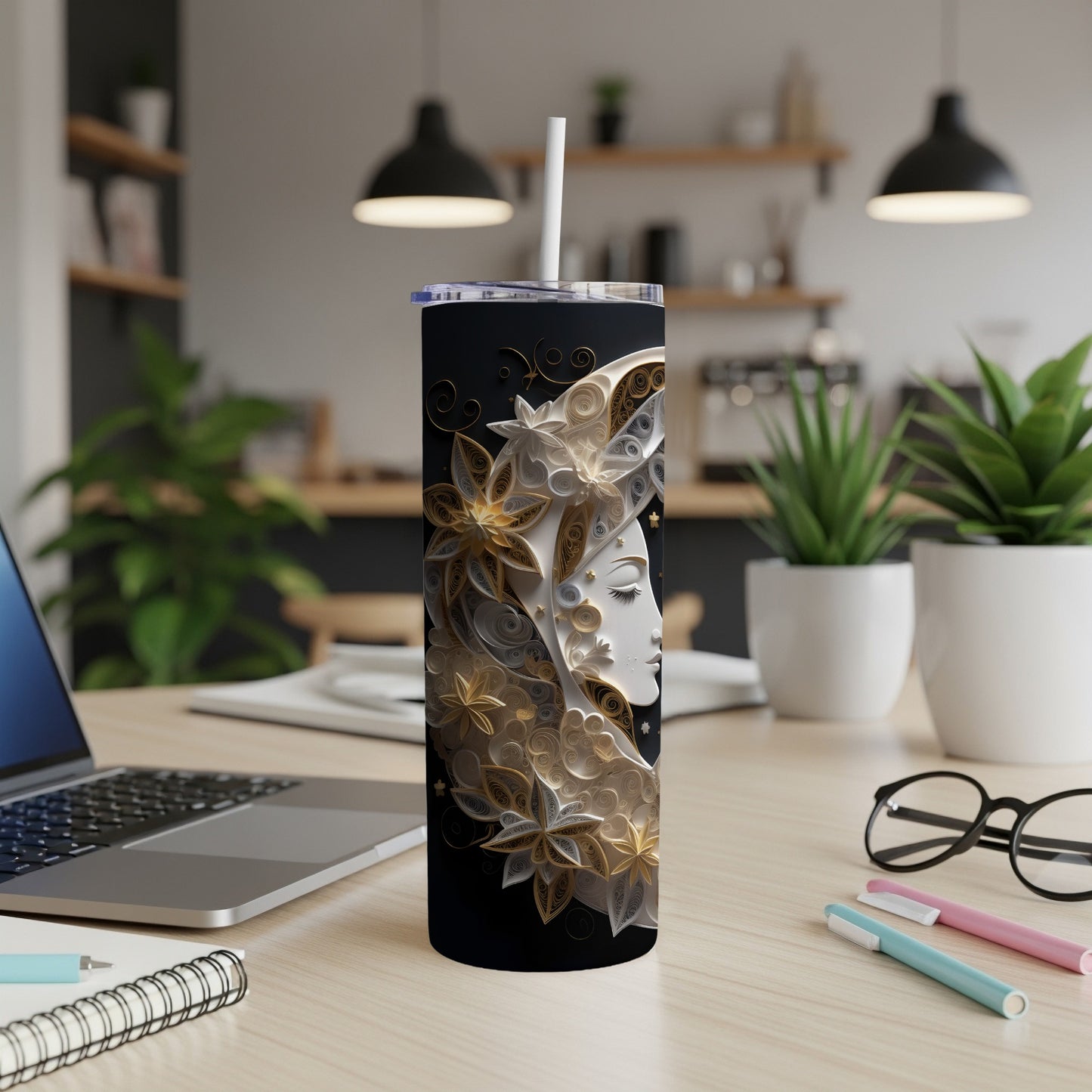 Black tumbler with celestial moon face and floral design.