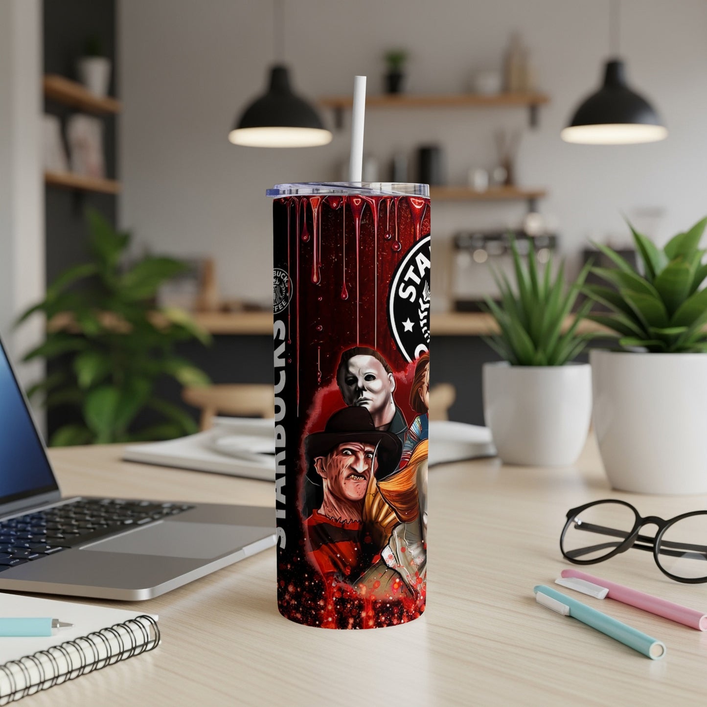 Horror movie characters on a Starbucks-themed tumbler with a straw.