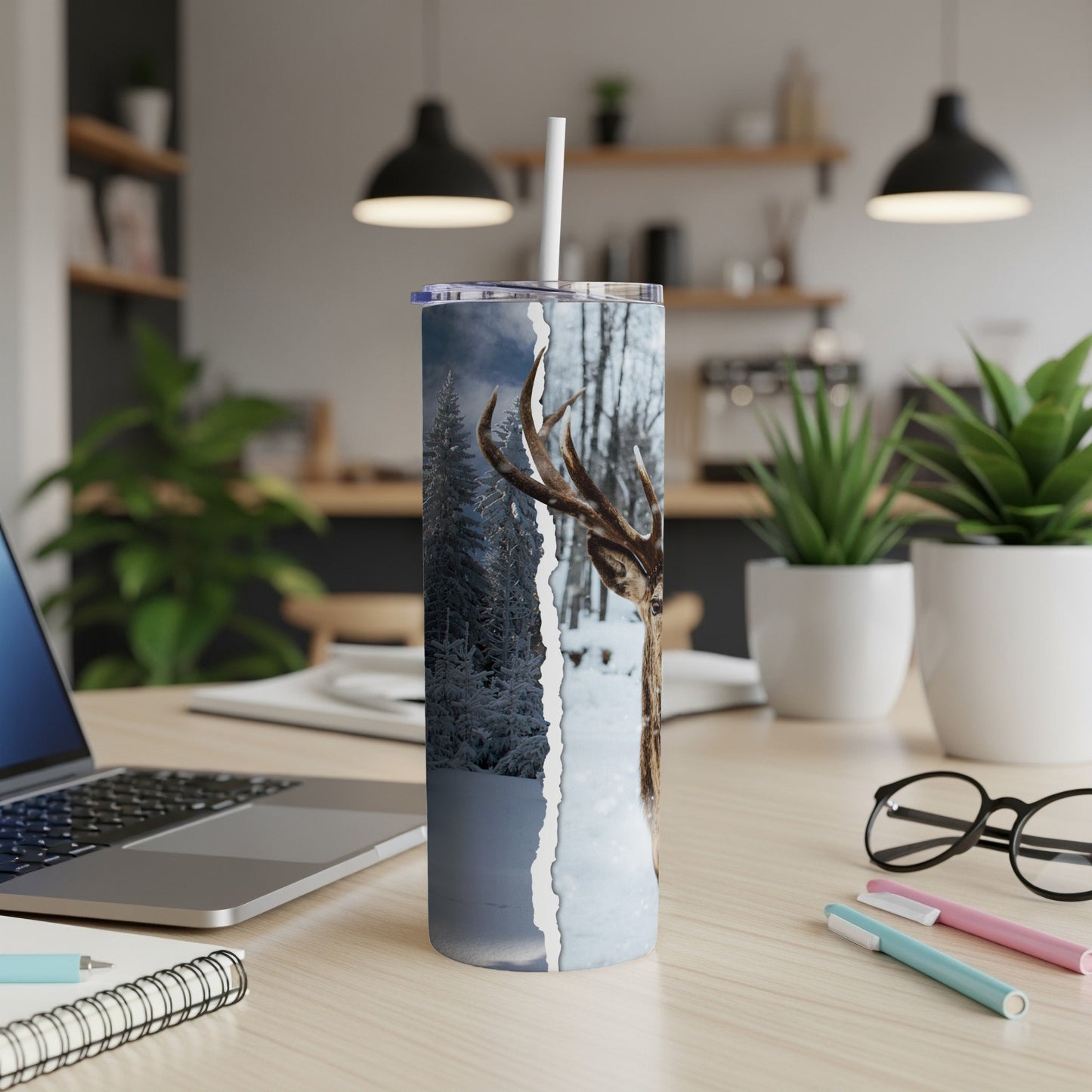 Deer in snowy forest on a white tumbler with a straw.