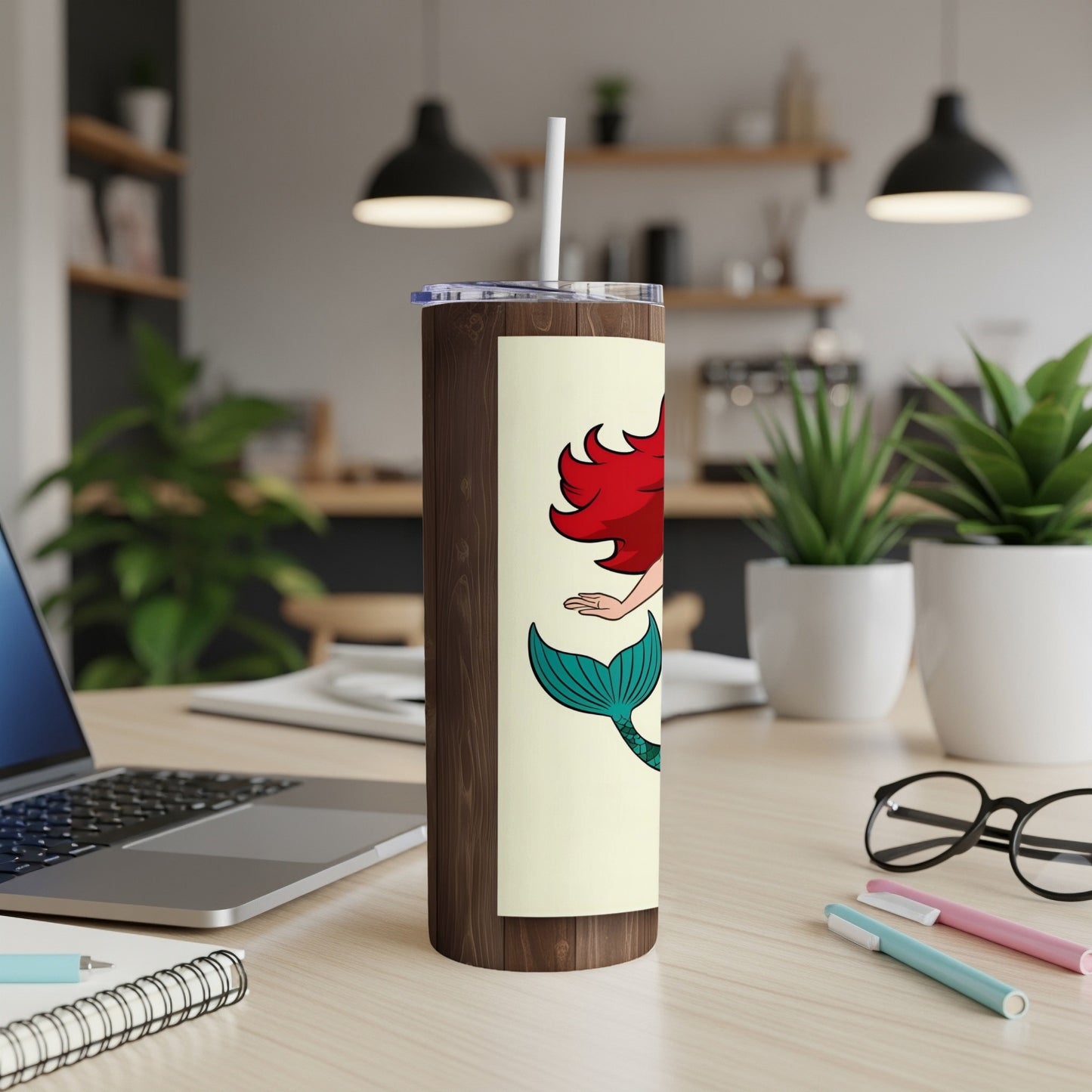 The Little Mermaid Ariel's tail on a woodgrain tumbler with a straw.