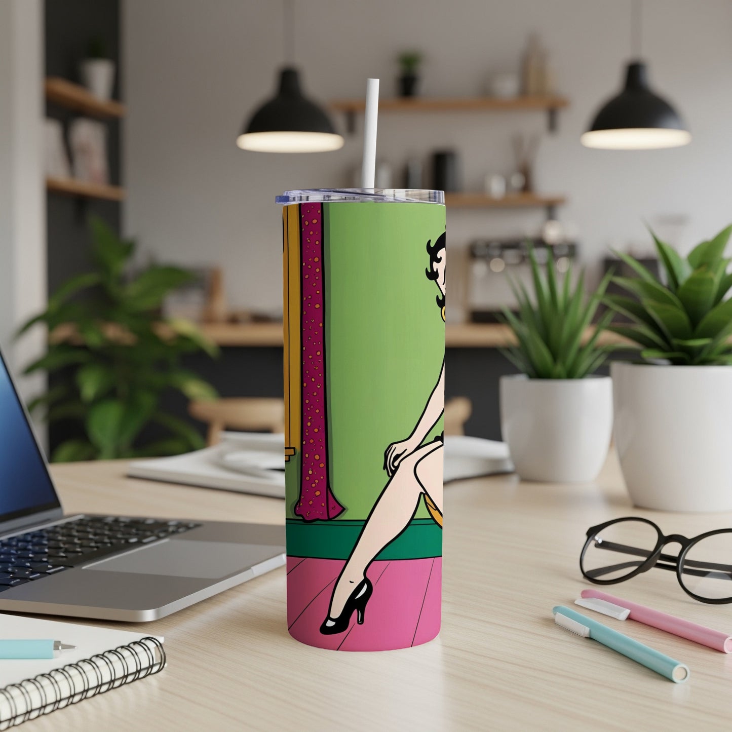 Betty Boop illustration on a green and pink tall tumbler with a straw.