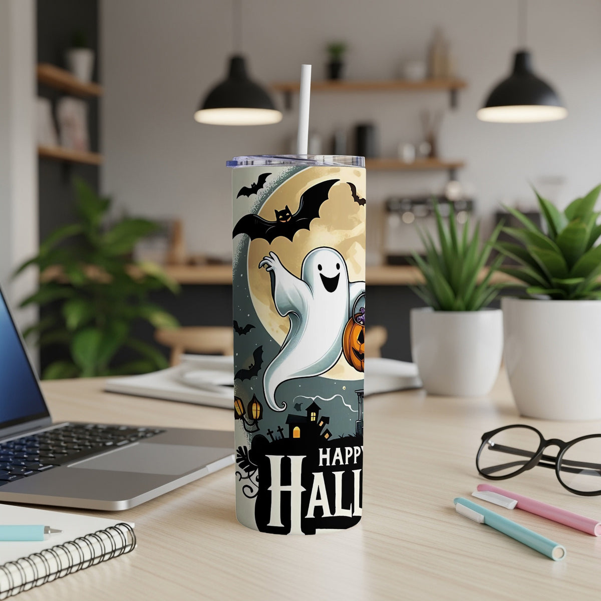 Tumbler with ghost, bats, pumpkin, and "Happy Halloween" text on a desk.