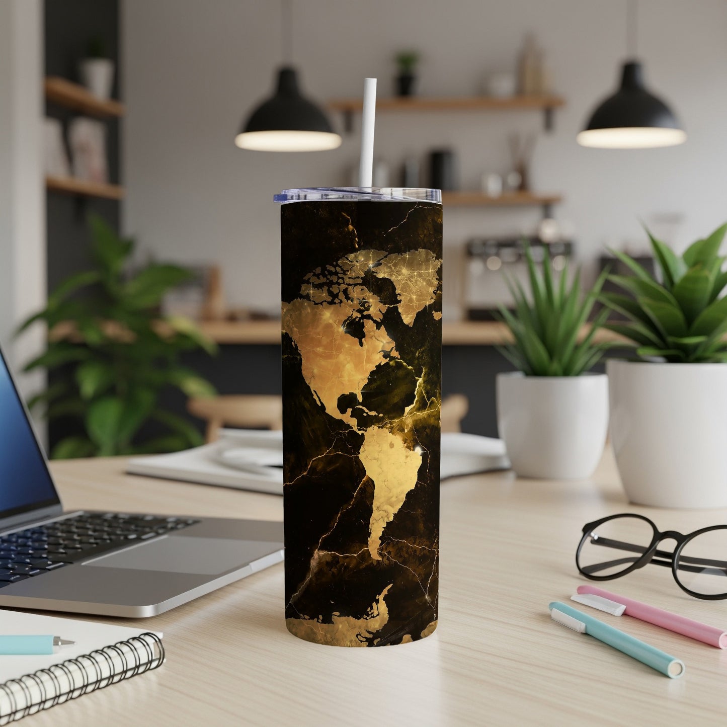 Tumbler with gold marble map of North and South America design and white straw.