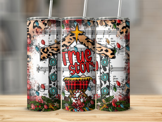 Christmas nativity scene tumbler with "True story" text and sheet music.