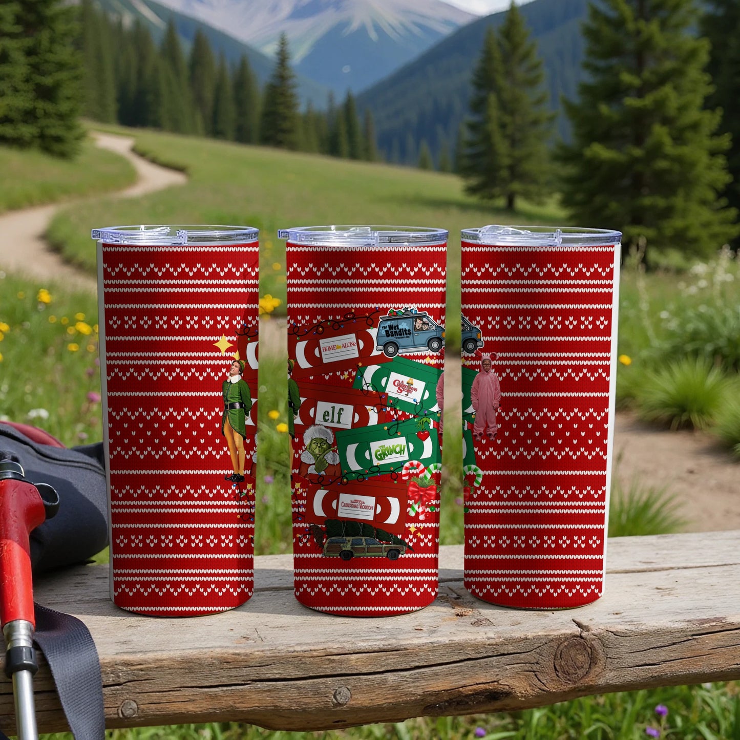Three red tumblers with Christmas movie icons and repeating patterns.