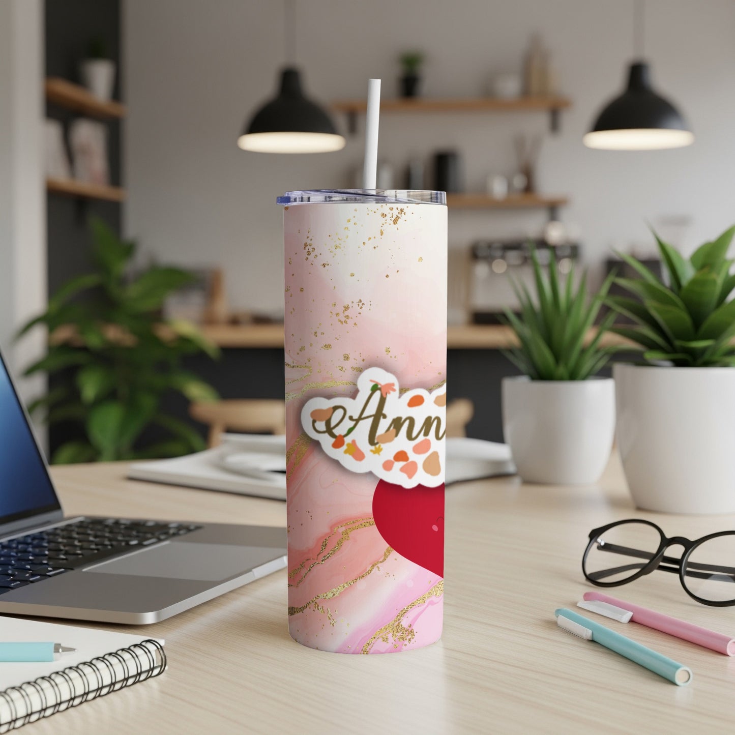 Pink marble tumbler with "Ann" text and red heart on desk.