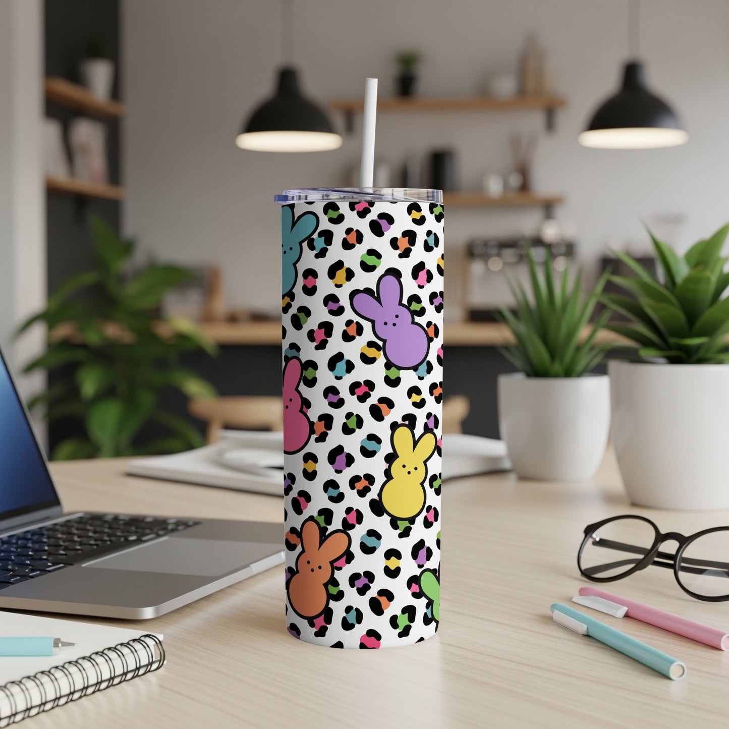 White tumbler with colorful leopard print and Easter bunny designs.