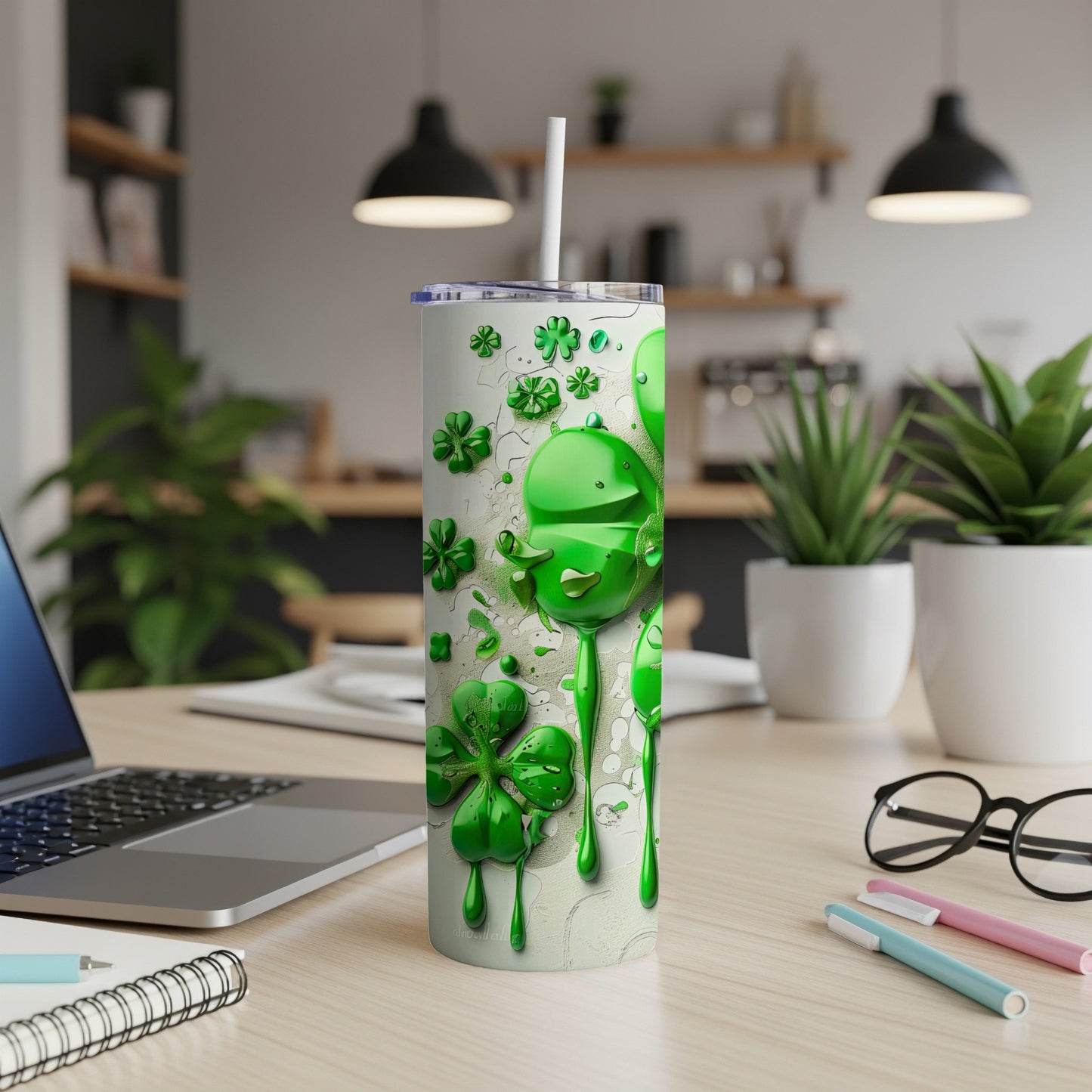 Green shamrocks and drips on a white tumbler with straw.
