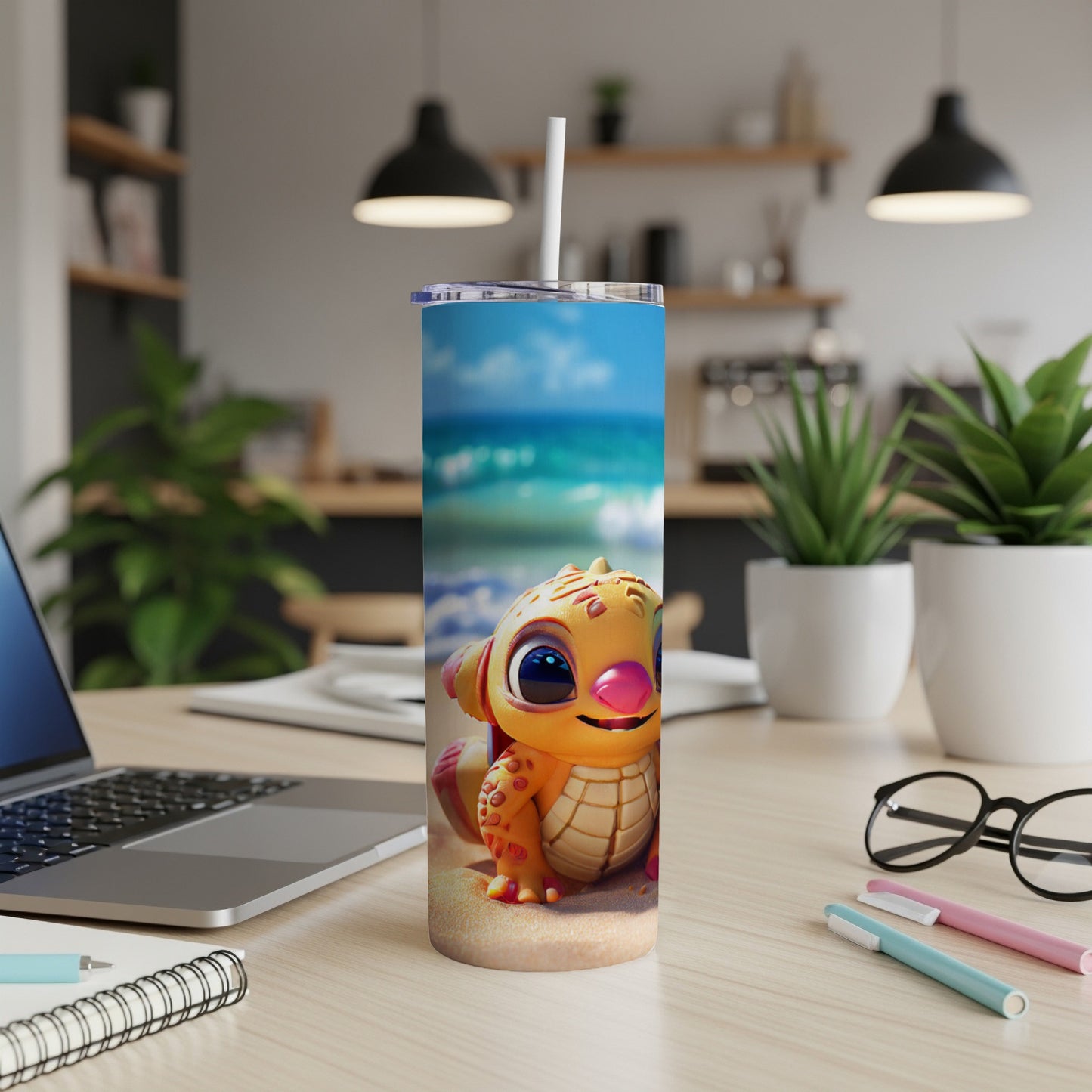 Cartoon dragon tumbler on desk with beach background.